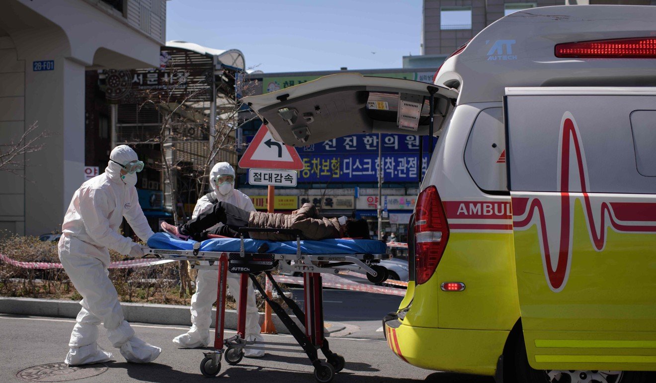 Medical workers attend to a woman who was feeling unwell upon her arrival at the Keimyung University hospital in Daegu. Photo: AFP