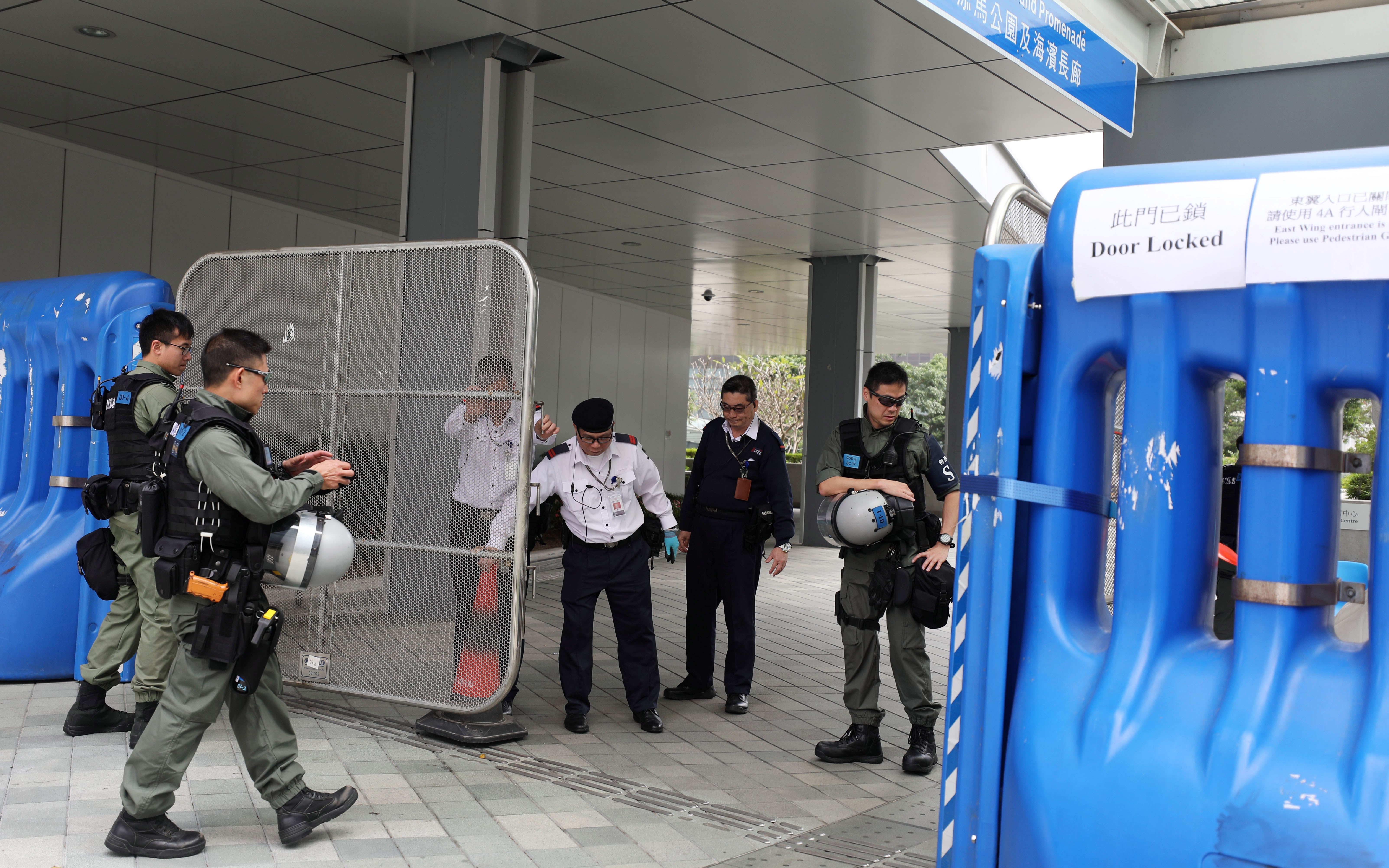 Riot police in front of water barriers at the heavily guarded government headquarters in Tamar. Photo: Xiaomei Chen