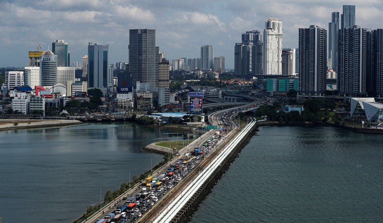 Commuters take the Woodlands Causeway to Singapore from Johor a day before Malaysia imposes a lockdown on travel due to the coronavirus outbreak. Photo: Reuters