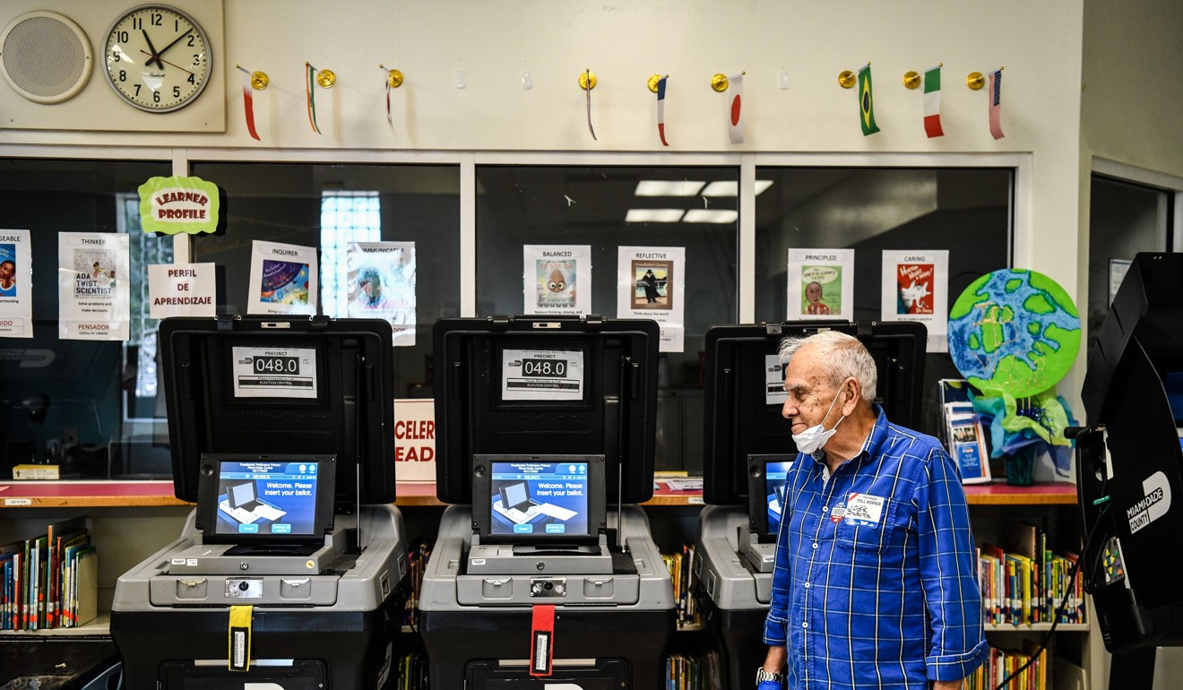 An election worker at a polling station in Miami. Photo: AFP