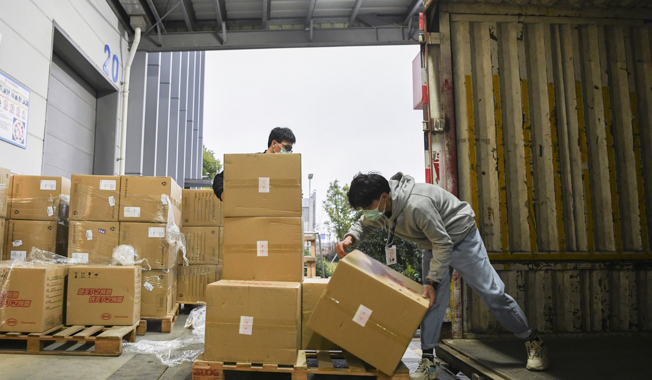 Workers loading boxes of surgical masks donated by China’s BYD, bound for the United States. Photo: Jack Ma Foundation