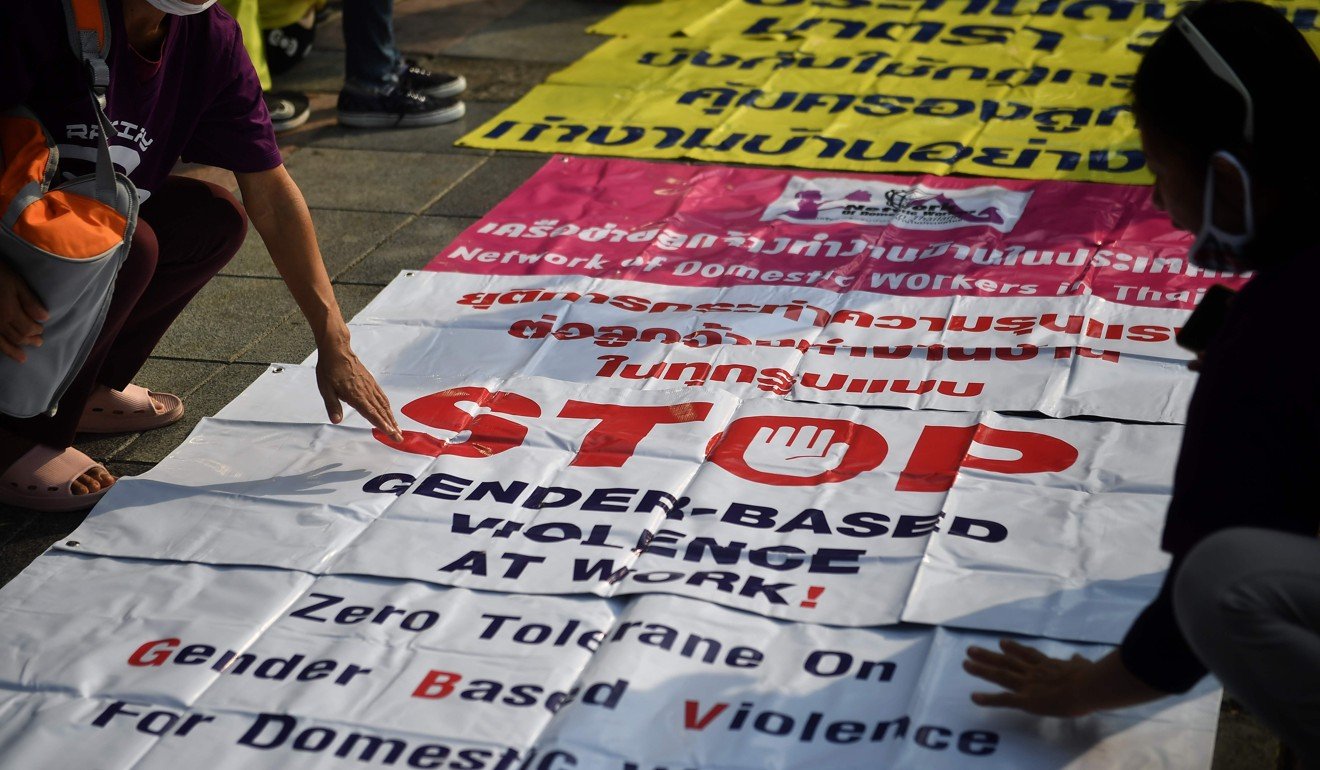 Members of Thai labour rights groups arrange signs calling for an end to gender-based violence at work before a protest earlier this month. Photo: AFP