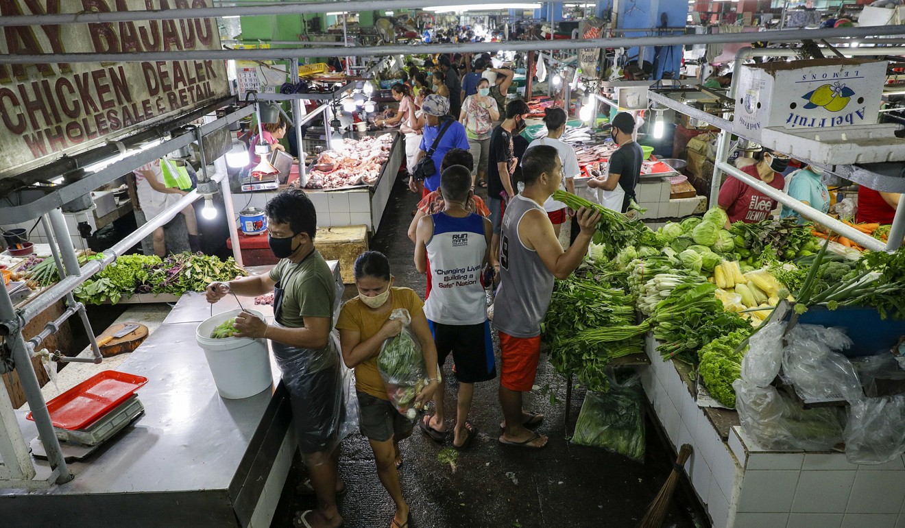 The Munoz market in Metro Manila has cuts its morning opening hours as part enhanced community quarantine measures. Photo: AP