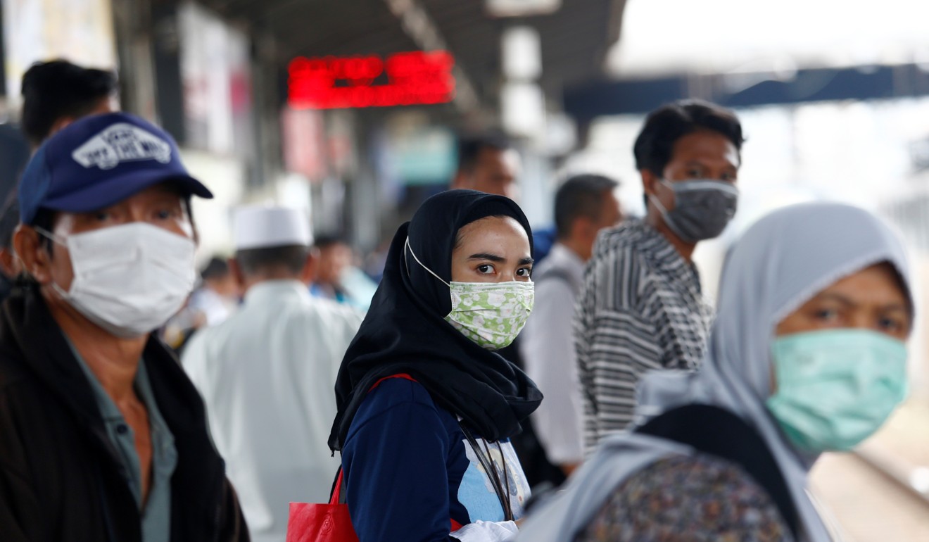 Indonesians wear surgical masks at a rail station in Tanah Abang, following the outbreak of the coronavirus. Photo: Reuters