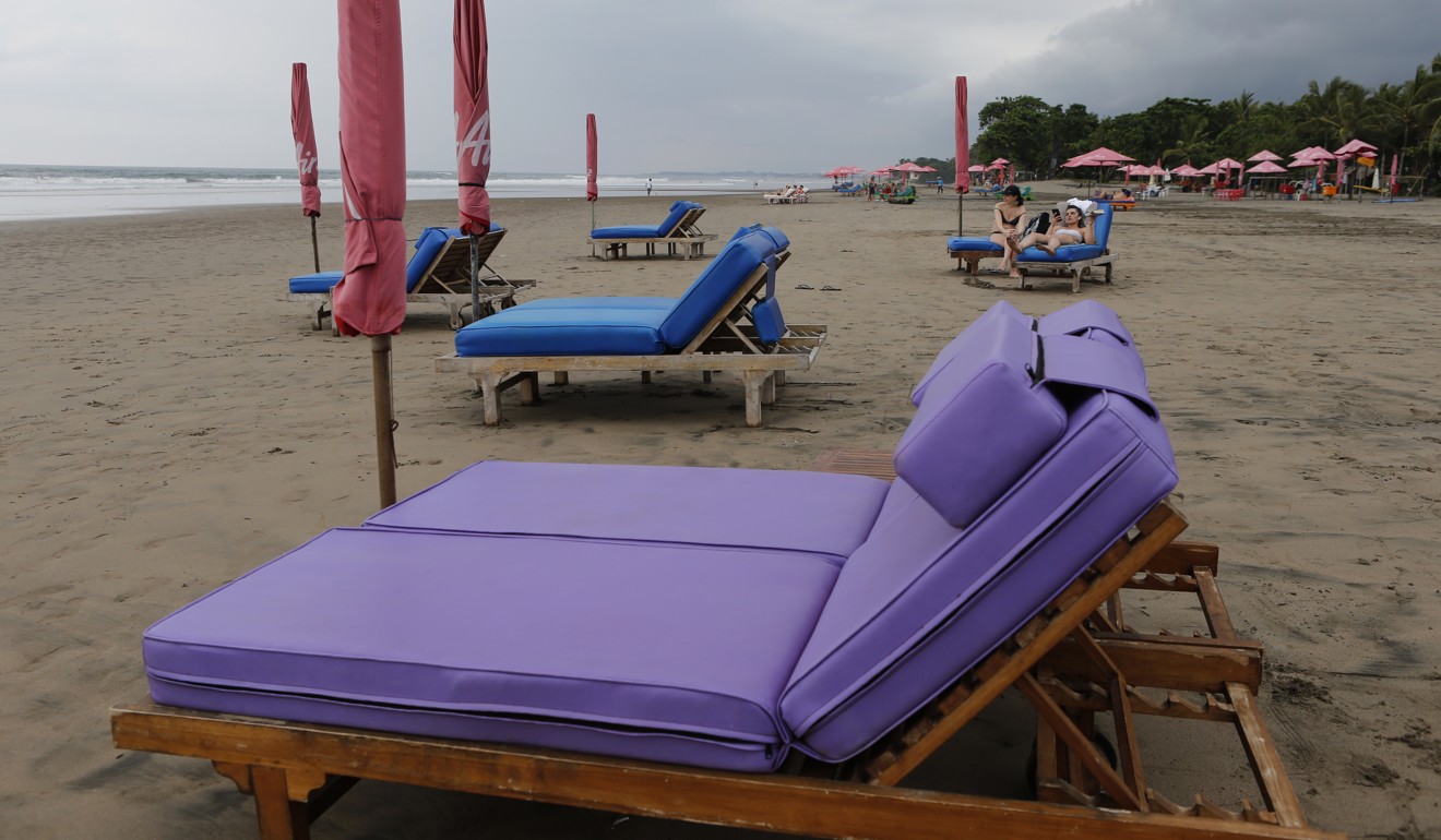 Empty sun chairs scatter a beach as tourism in Bali has dropped due to the coronavirus outbreak. Photo: AP