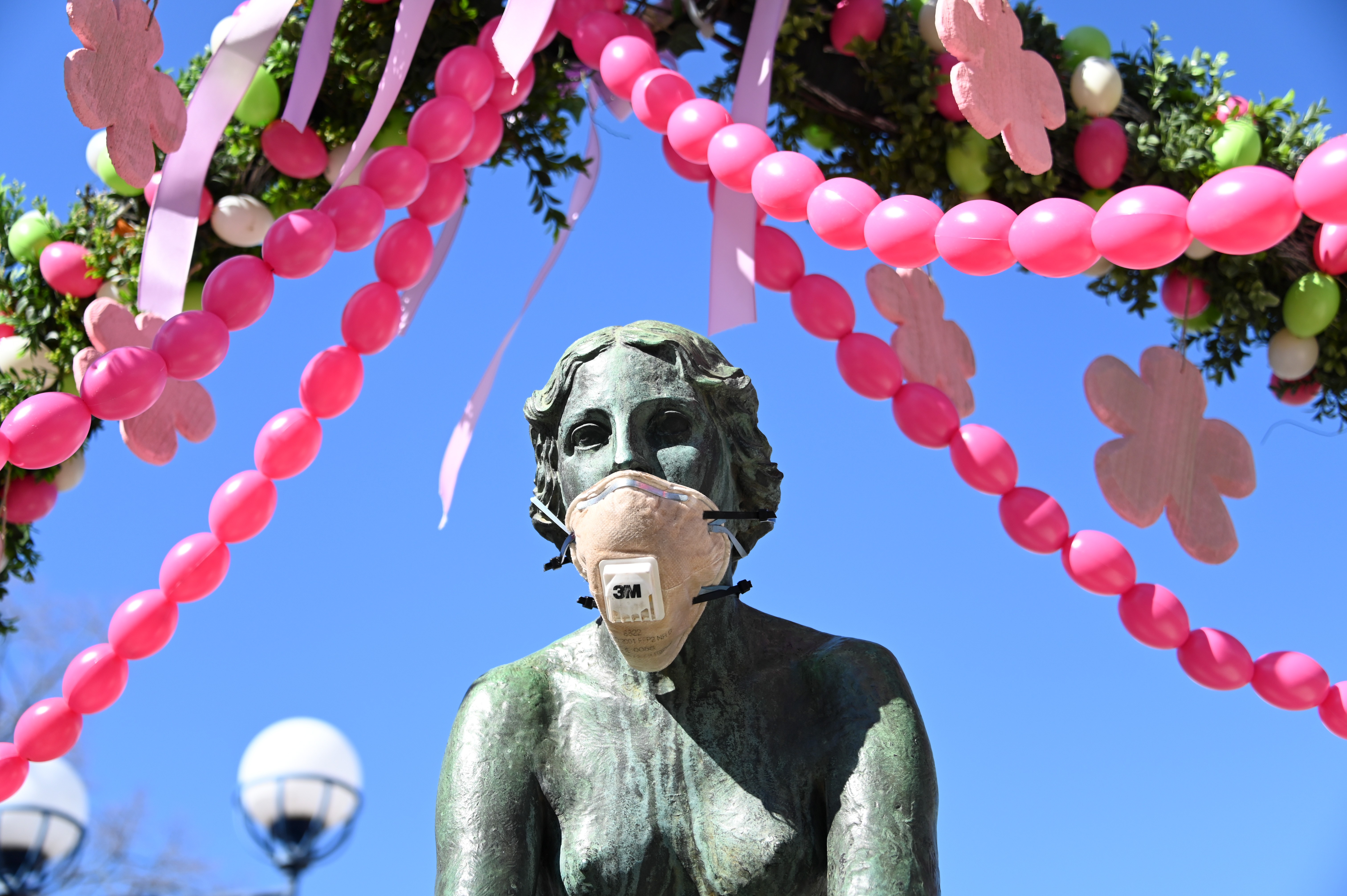 A face mask placed on The Nymph fountain in Bad Wildungen. Germany has introduced drastic restrictions on public life and strict travel bans as part of efforts to curb the spread of the coronavirus. Photo: DPA