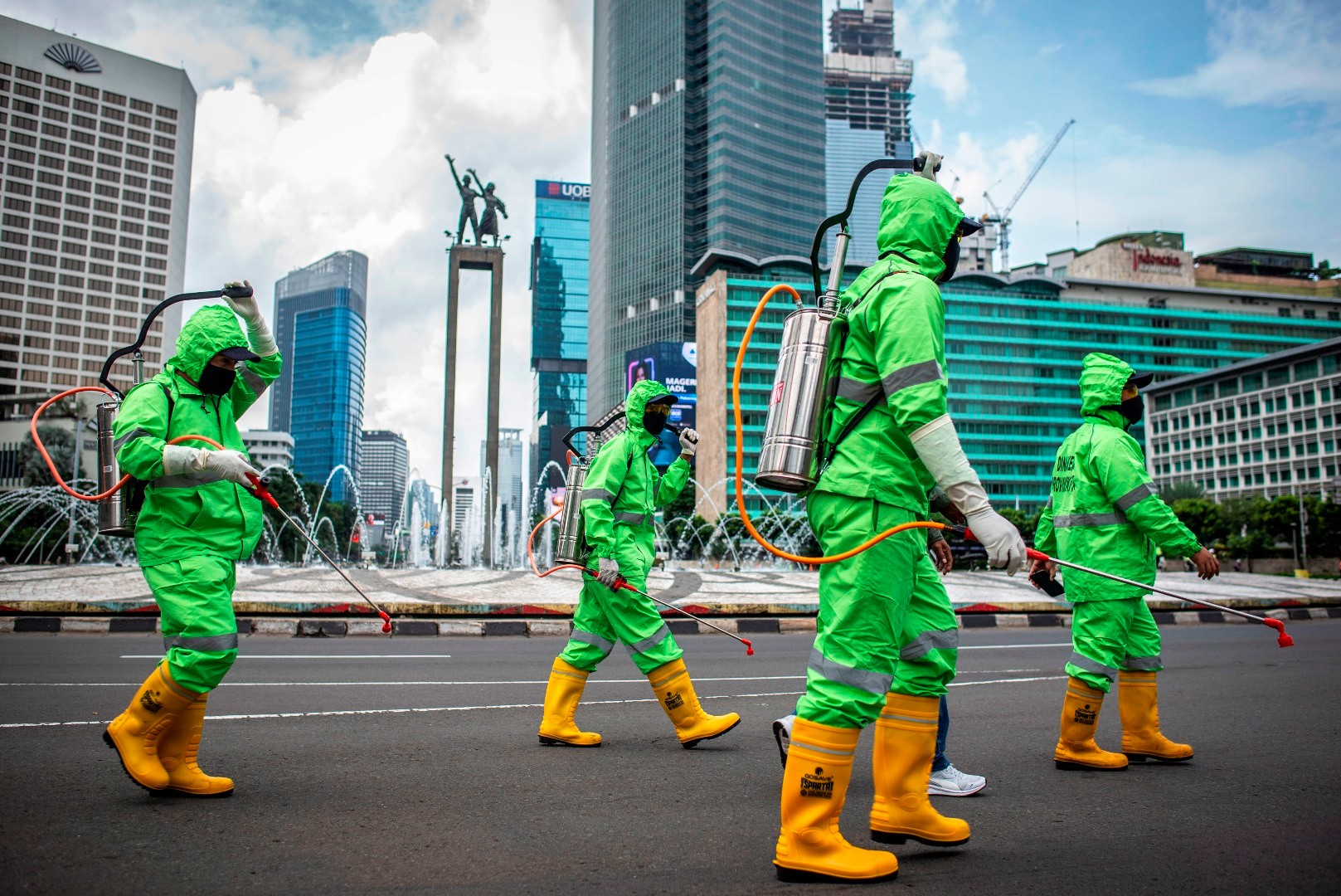 Workers spray disinfectant in Jakarta, Indonesia, on March 22, 2020. Photo: Antara Foto via Reuters