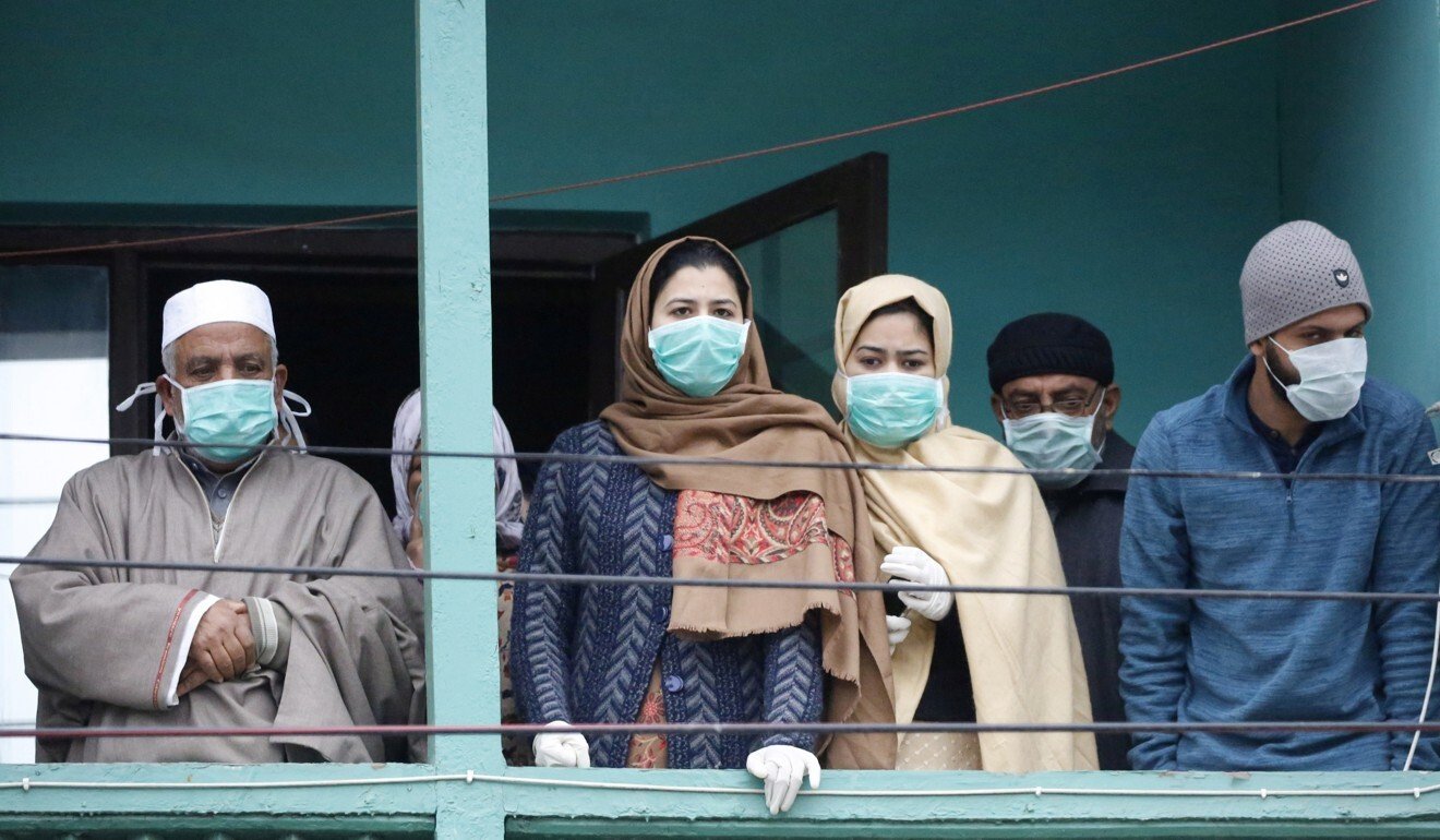 A group of people who returned to Kashmir from the Gulf look on from a hotel in Srinagar, where they have been kept in quarantine. Photo: EPA-EFE