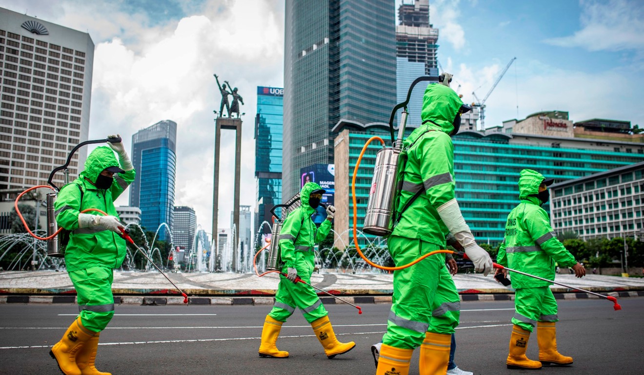 Workers disinfect areas of Jakarta, Indonesia, to prevent the spread of the coronavirus disease, Covid-19. Photo: Reuters