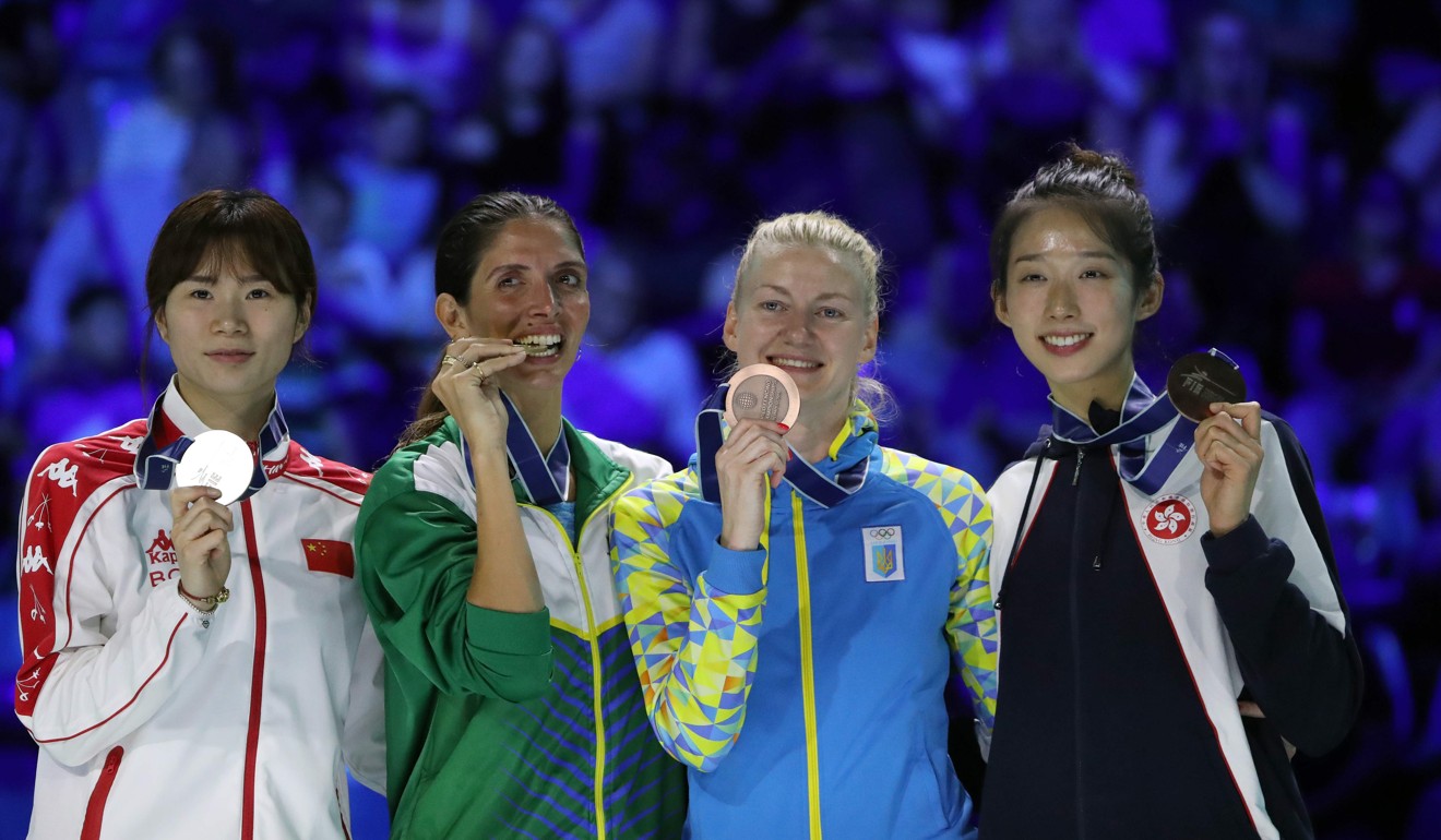 Vivian Kong (right) proudly shows her 2019 world championship bronze medal in Budapest, the first for Hong Kong. Can she do it again in Tokyo next year? Photo: AFP