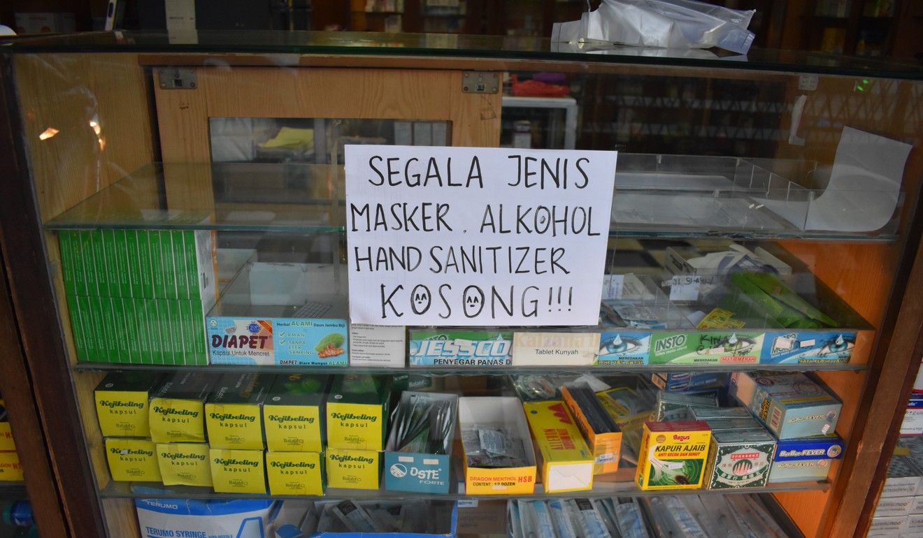 A pharmacy sign in Indonesia says ‘All masks, alcohol and hand sanitiser are sold out’. Photo: Aisyah Llewellyn