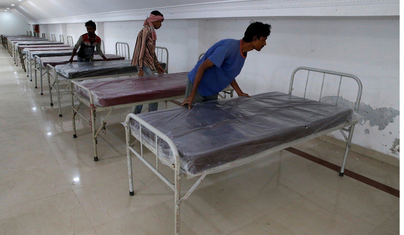 Workers prepare beds to set up a quarantine facility in Howrah on the outskirts of Kolkata. Photo: Reuters