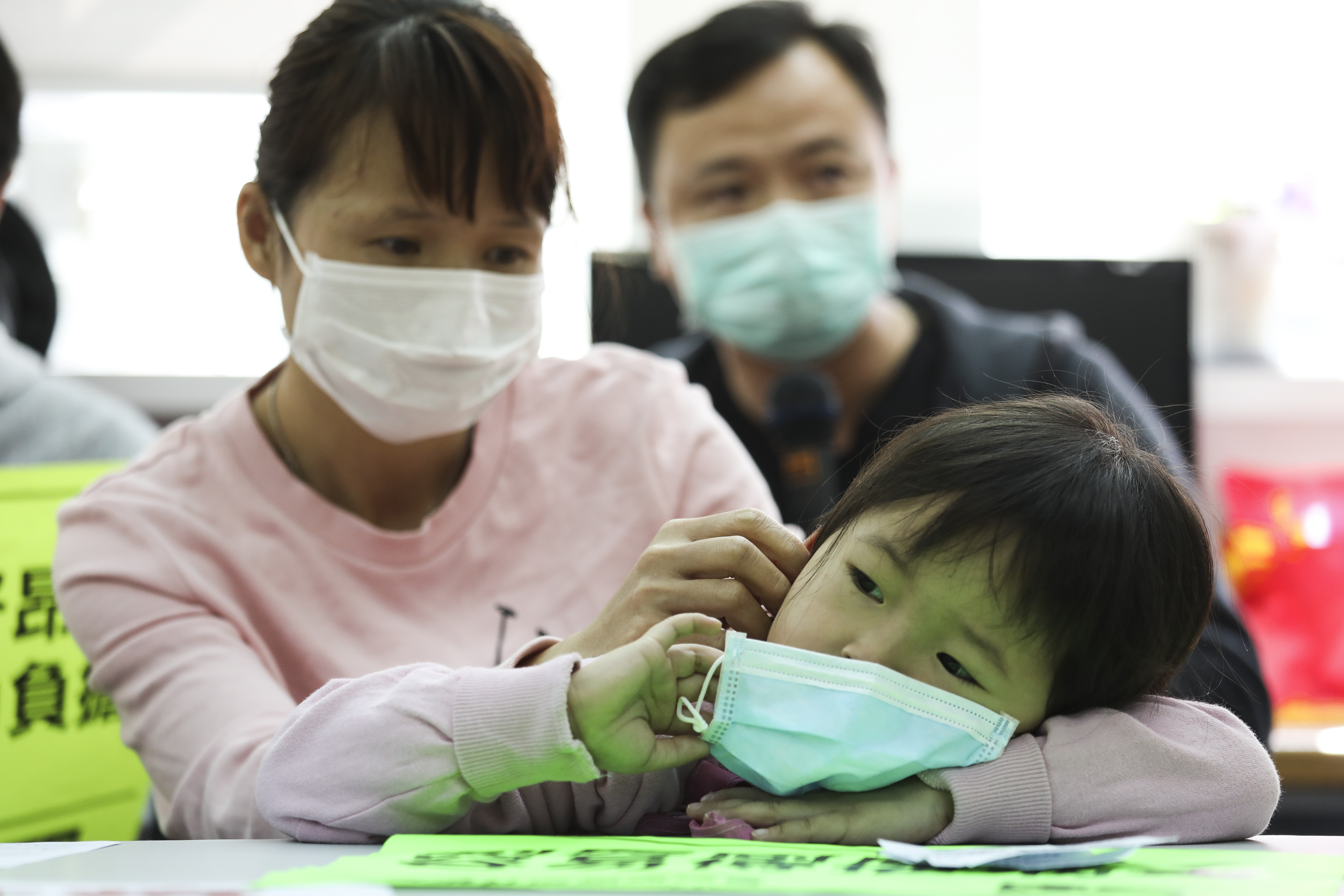 Four-year-old Huang Zijuan and her mother Wen Qifei (left) share the difficulties they have faced amid the coronavirus epidemic during a press conference organised by Society for Community Organisation in Sham Shui Po on February 23. Photo: Nora Tam