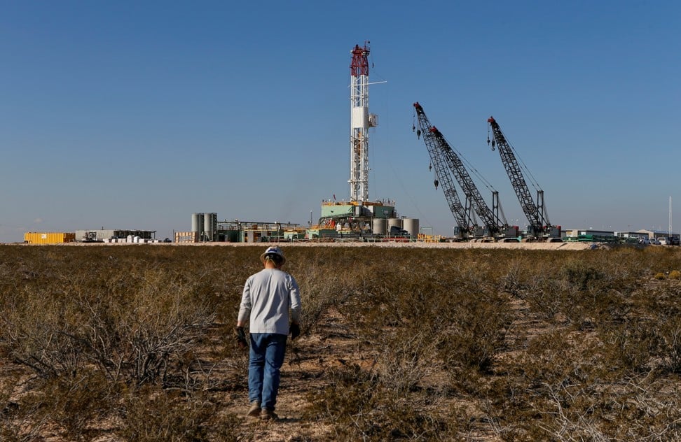 An oil worker walks towards a drill rig in Loving County in Texas, US, in November last year. Texas regulators are considering whether the US should curtail crude oil production for the first time in decades. Photo: Reuters