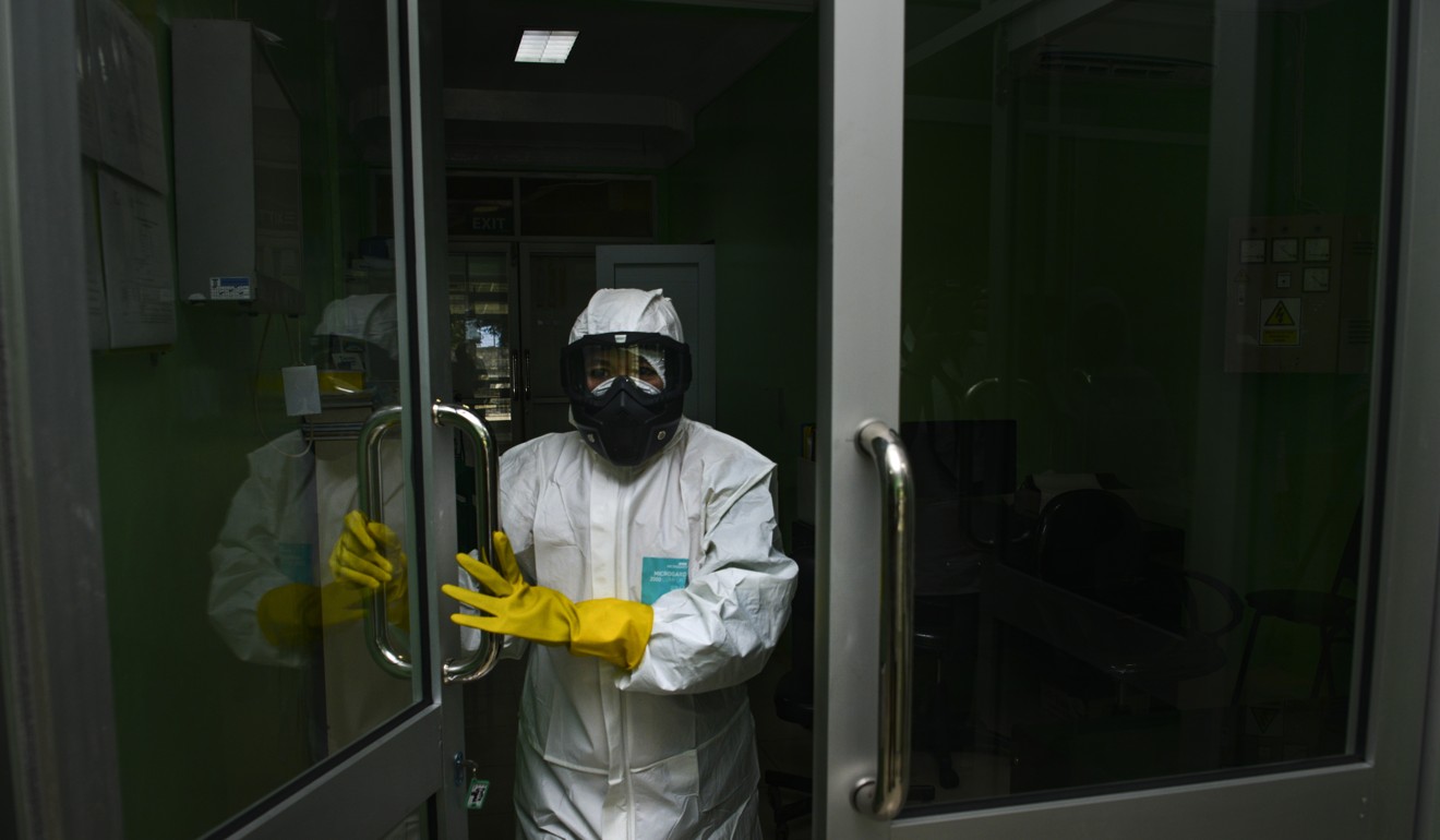 A health worker in protective gear walks into a quarantine room at a hospital in Banda Aceh, Indonesia. Photo: AFP