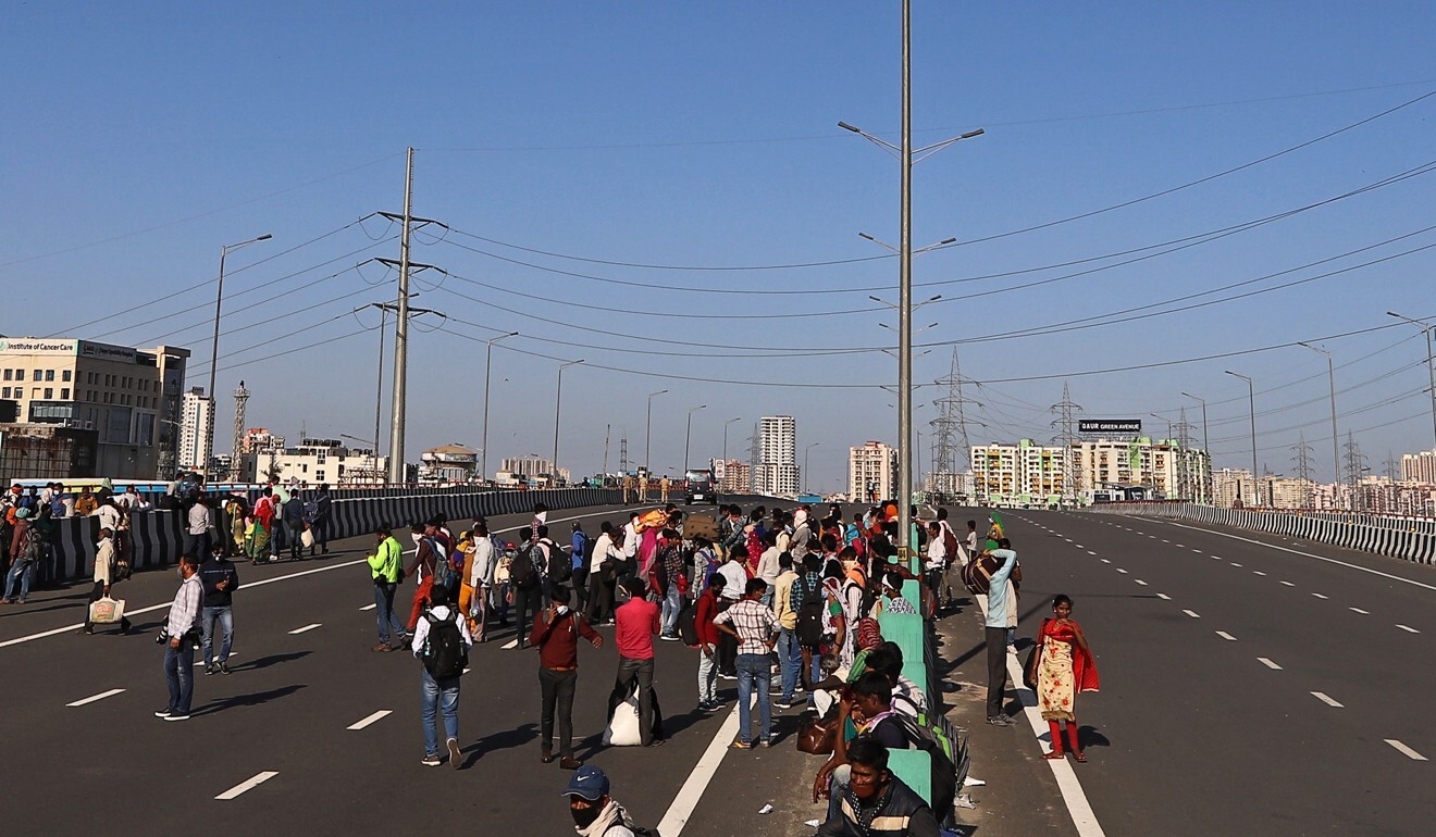 Migrant workers and their families walk along a motorway on Sunday. Photo: Bloomberg