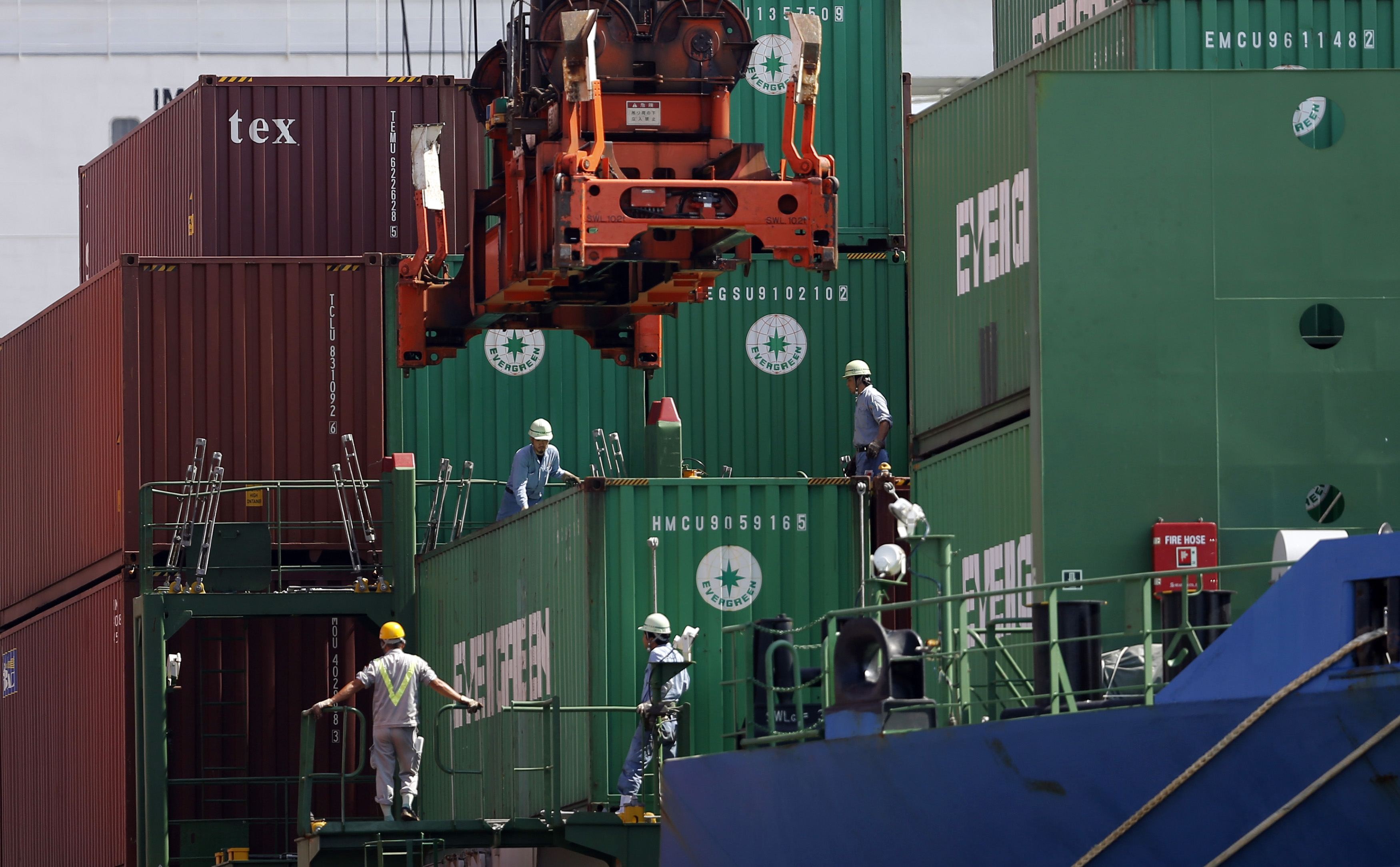 Crew watch as a container is loaded on to a cargo ship in Tokyo. The International Chamber of Shipping estimates that at least 100,000 seafarers a month need to change over from the ships they work on. Photo: Reuters