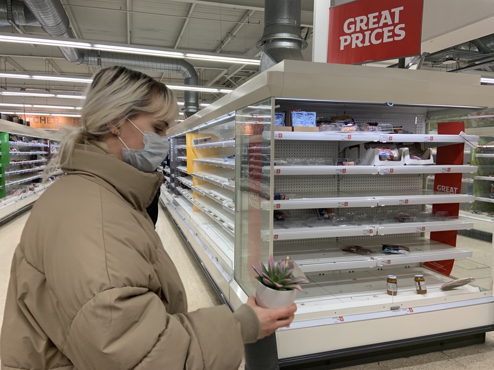 A woman walks past empty shelves in Sainsburys, Whitechapel, London, amid the coronavirus pandemic. Photo: Hilary Clarke
