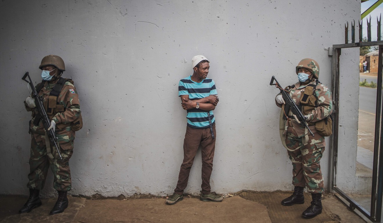A man is questioned by a South African National Defence Force (SANDF) patrol. Photo: AFP