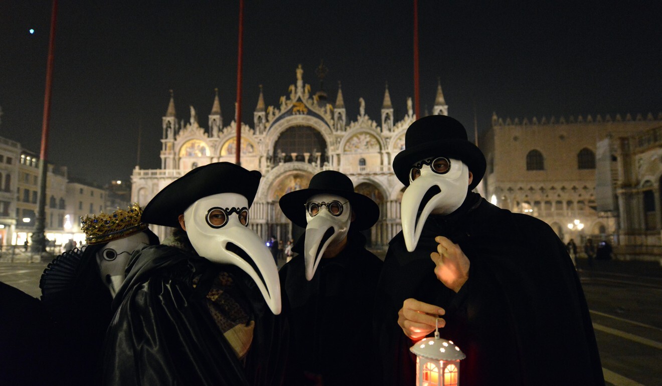 Masked revellers take part in the ‘Plague Doctors Procession’ on Saint Mark Square in Venice in February. Photo: AFP