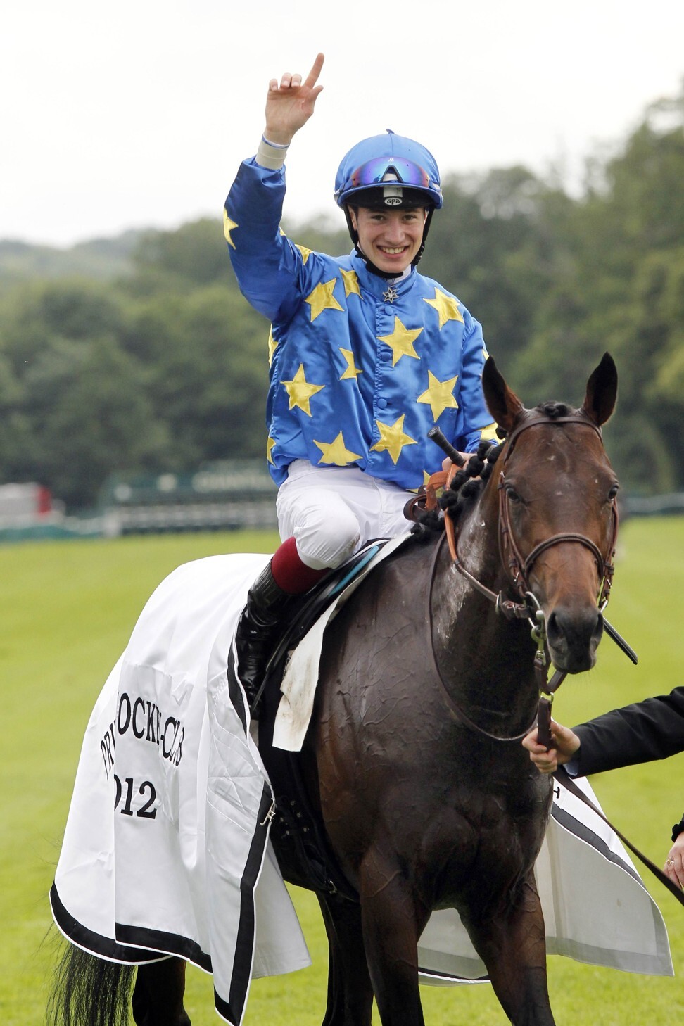 Antoine Hamelin ridding Saonois, celebrates his victory in the French Derby. Photo: AFP