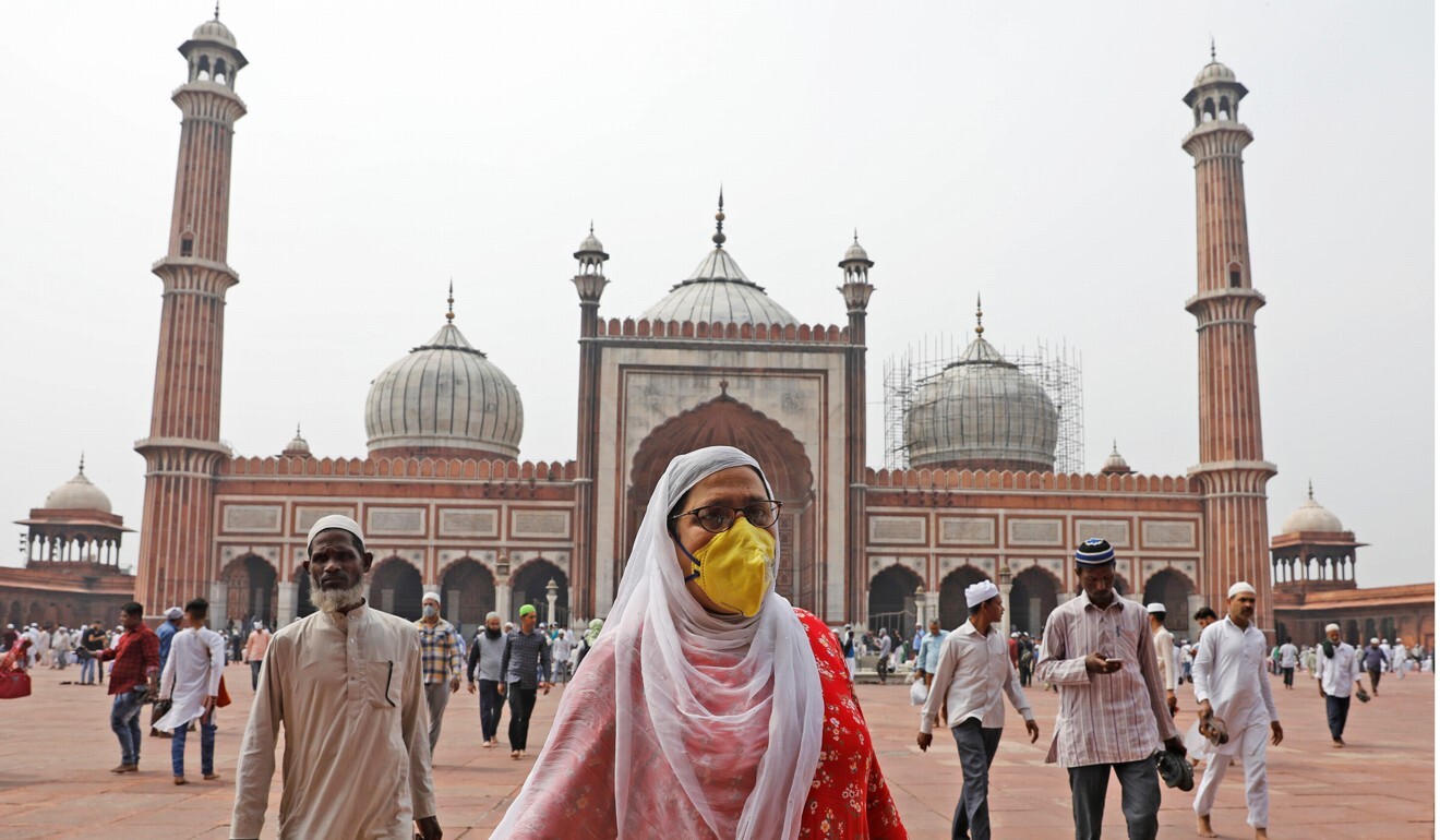 A woman wearing a protective mask leaves after attending the Friday prayers at the Jama Masjid (Grand Mosque) in the old quarters of Delhi, India, on March 20. Photo: Reuters