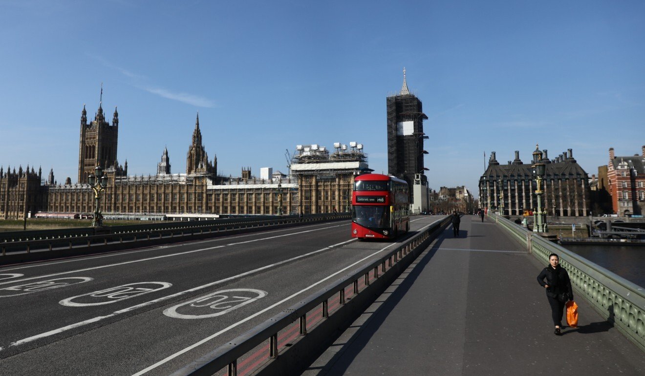 A commuter walks along Westminster bridge in London during the coronavirus lockdown. Photo: Bloomberg