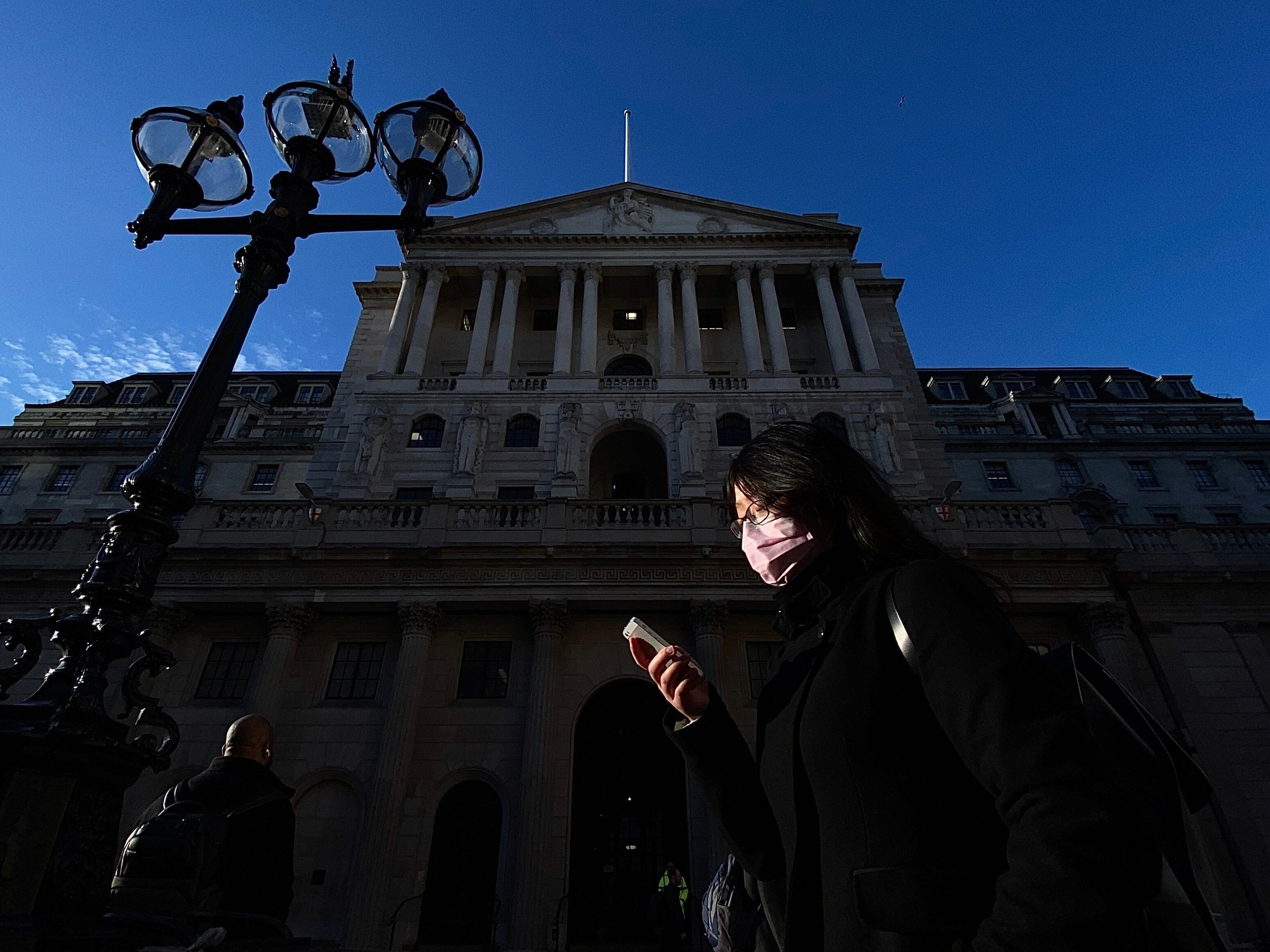 Dark times: a pedestrian passes the Bank of England during the coronavirus lockdown. Photo: AFP