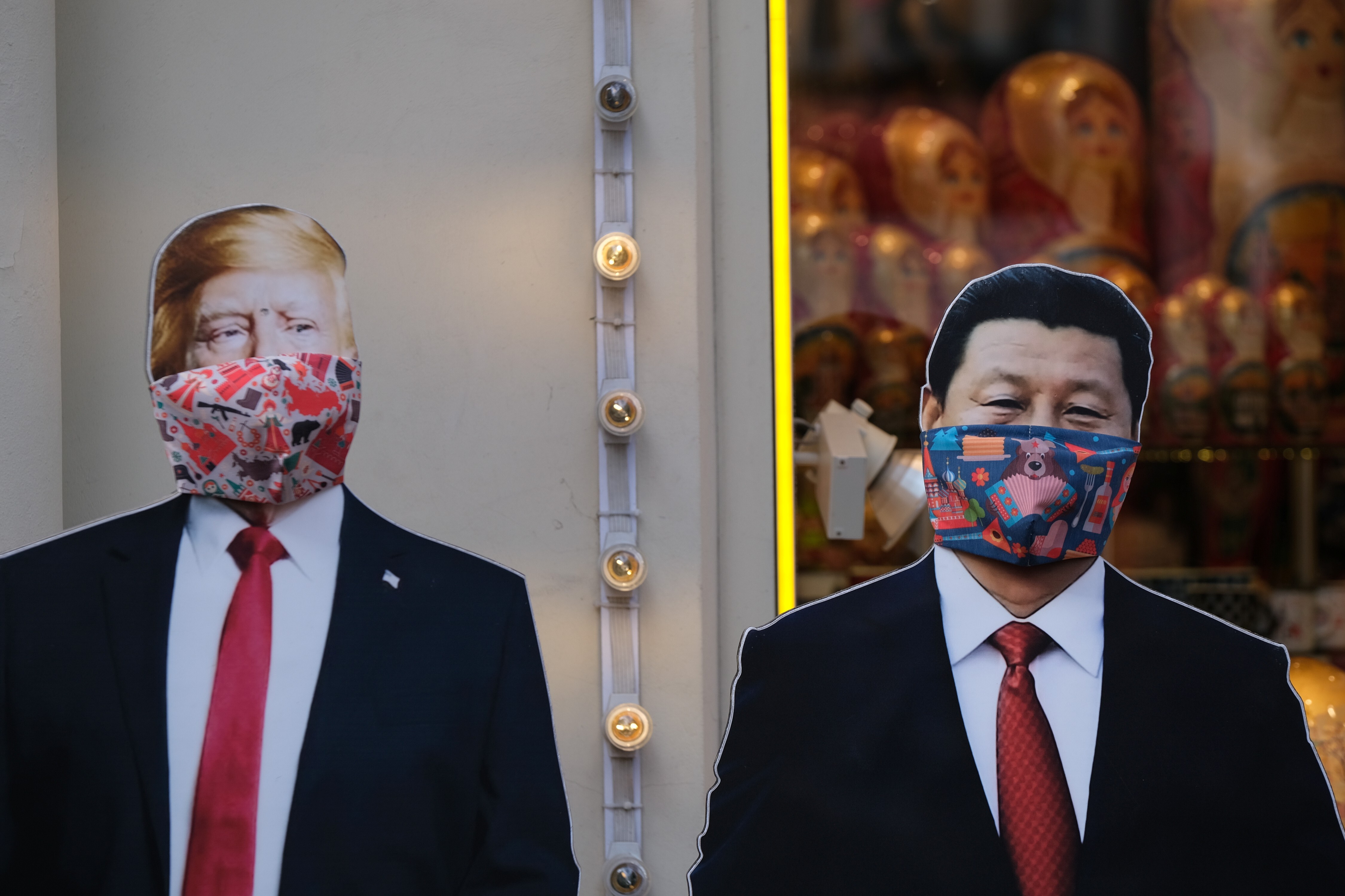 Cardboard cut-outs of US President Donald Trump and Chinese President Xi Jinping wearing face masks stand outside a gift shop in Moscow on March 23. The US has said China is suppressing information related to Covid-19, while China says the US is stigmatising its efforts. Photo: Reuters