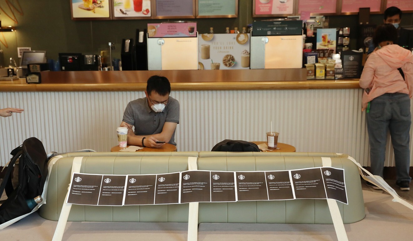 A man having a coffee in Kwun Tong after the new social-distancing laws kicked in. Photo: K.Y. Cheng