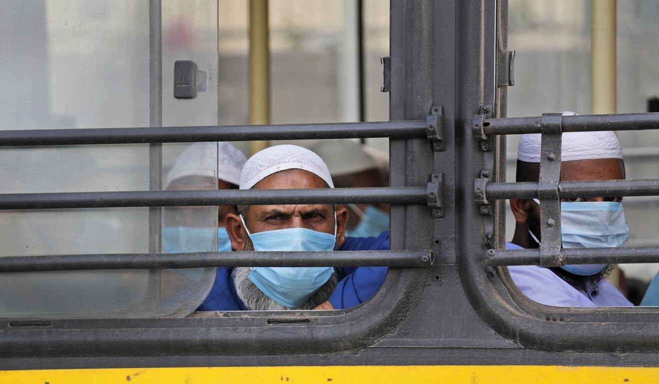 Muslim pilgrims wait in bus that will take them to a quarantine facility from the Nizamuddin area of New Delhi, India. Photo: AP