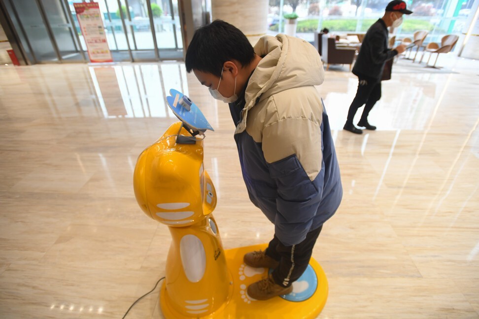 A robot that measures a person’s temperature is part of government efforts to curb the spread of Covid-19 in central China’s Hunan province. Photo: Xinhua