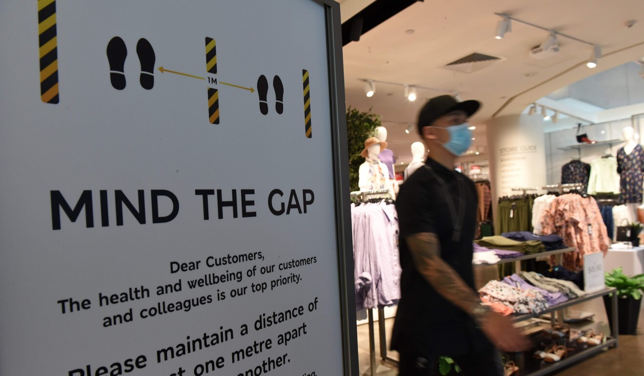 A man walks past a notice alerting customers to keep one metre apart, as part of efforts to minimise the spread of Covid-19 at a shopping centre in Singapore on March 28. Photo: AFP