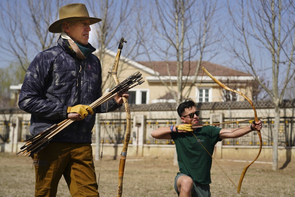 Lindesay and his youngest son, Tommy, practise archery near their Beijing home with traditional Mongolian bows. Photo: courtesy of William Lindesay