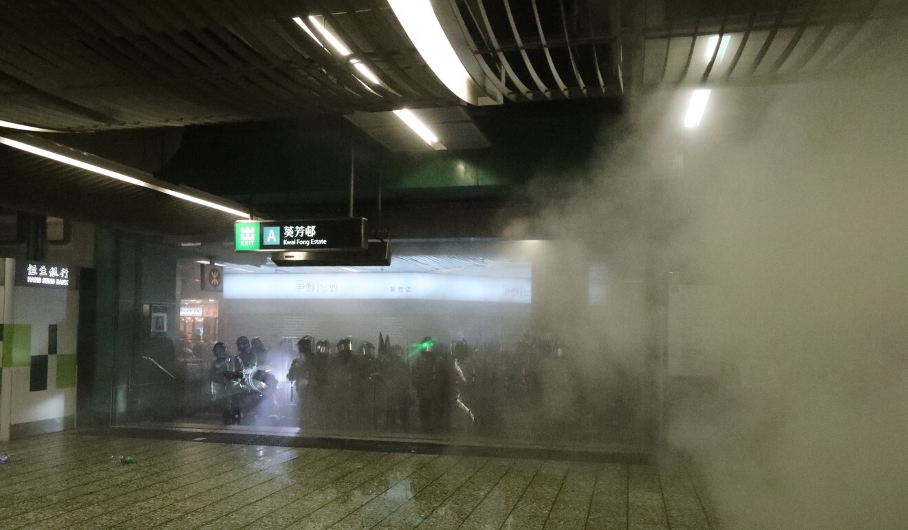 Riot police fire tear gas in Kwai Fong MTR station. Photo: Felix Wong