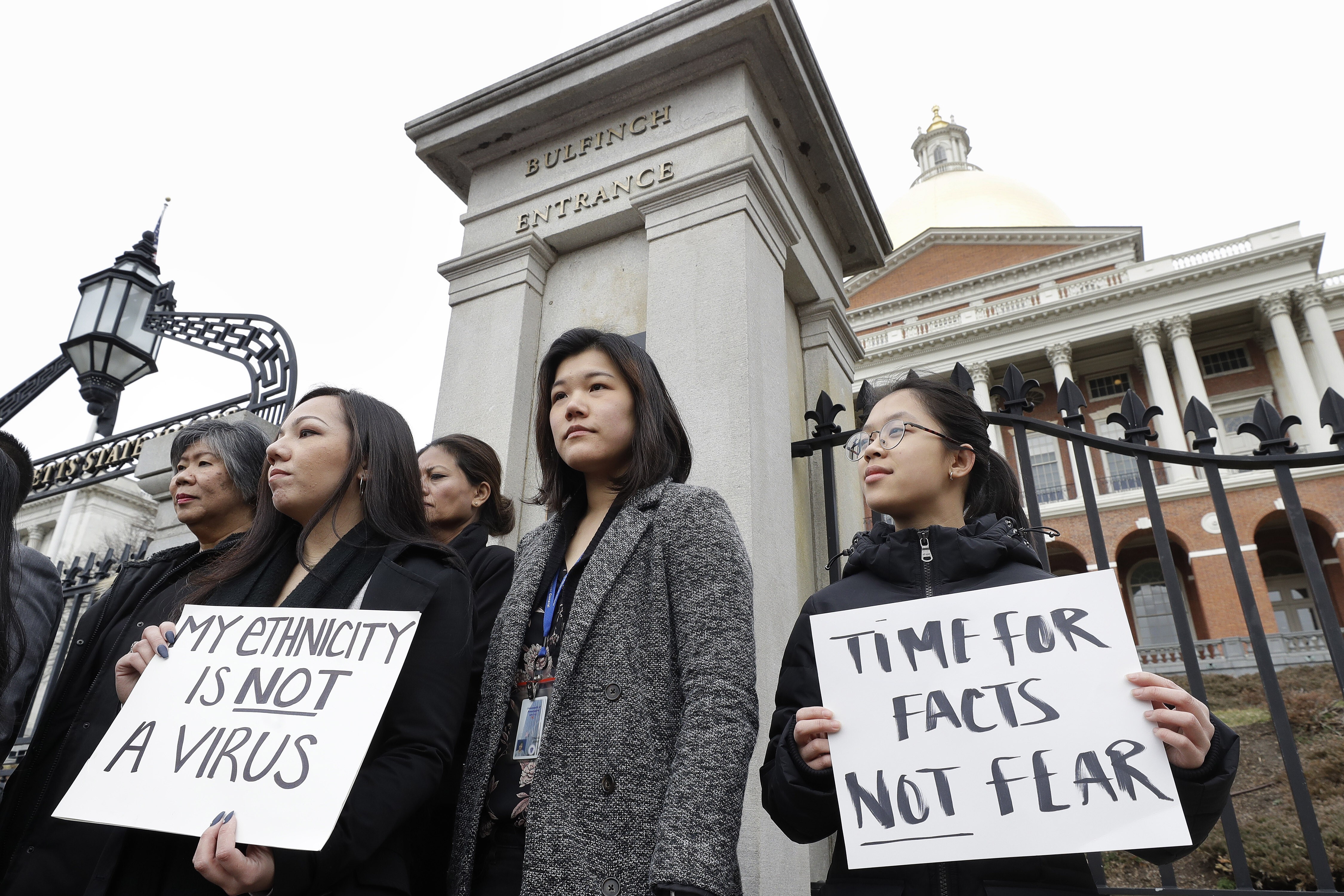 Asian-Americans from Boston’s Asian-American Commission protest on the steps of the Statehouse on March 12, against racism, fearmongering and misinformation aimed at Asian communities amid the pandemic. Photo: AP