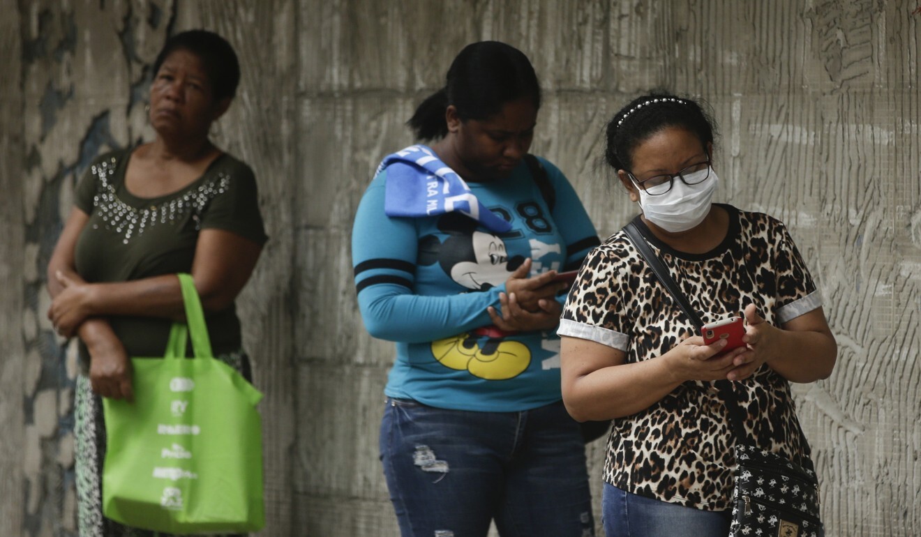 Women practice social distancing as they wait in line to enter a supermarket in Panama City. Photo: AP Photo