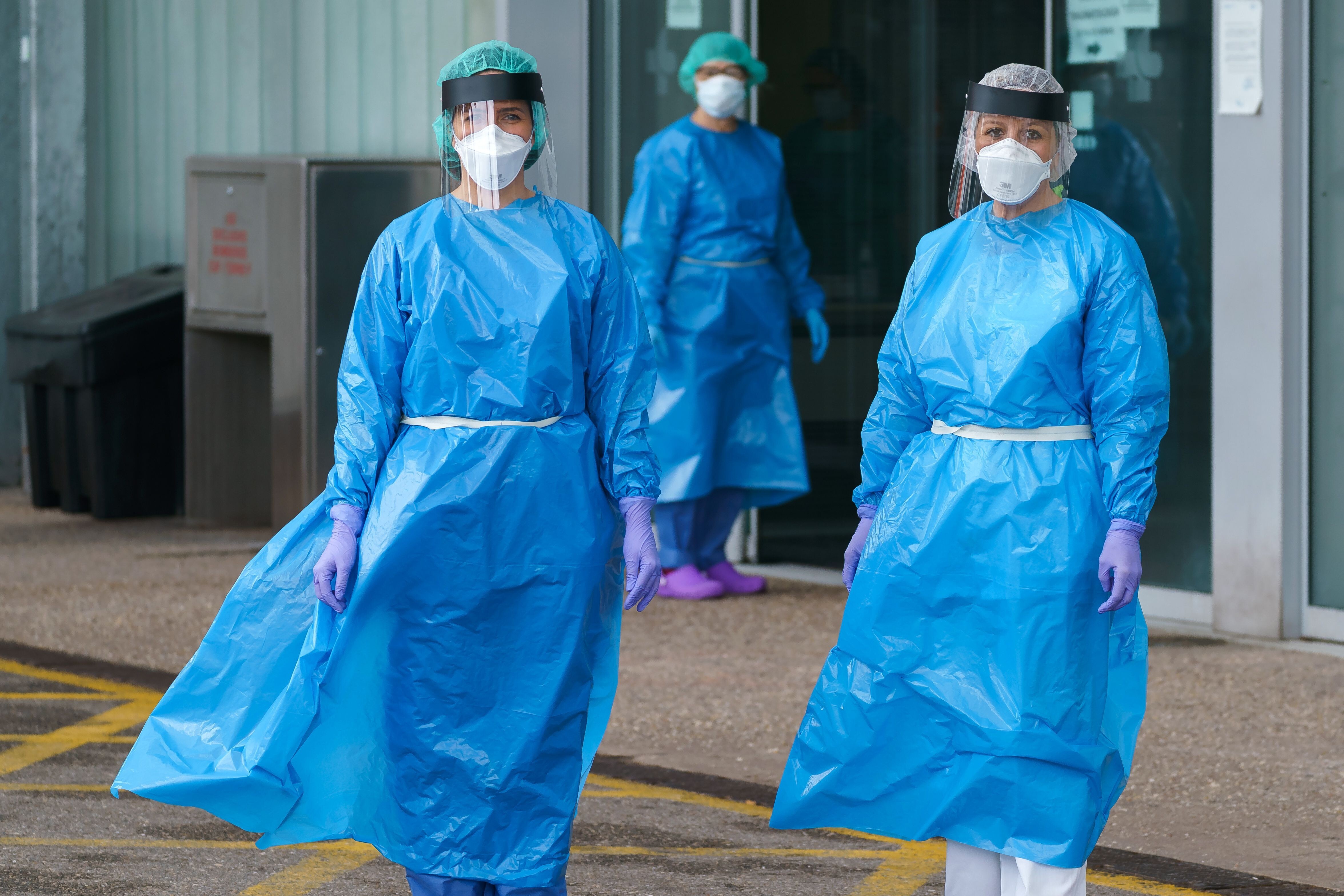 Health workers in protective gear outside an emergency entrance to a hospital in northern Spain. Photo: AFP