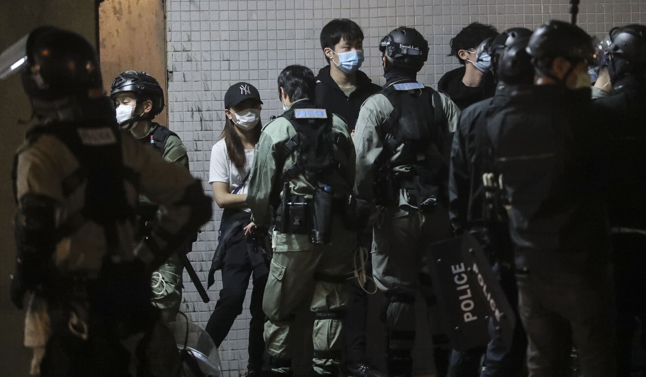 Riot police stop and search protesters in Tseung Kwan O on March 8. Photo: Edmond So