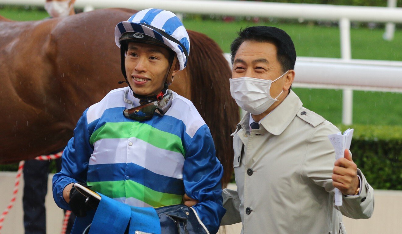 Jockey Vincent Ho (left) and trainer Ricky Yiu celebrate Voyage Warrior’s win.