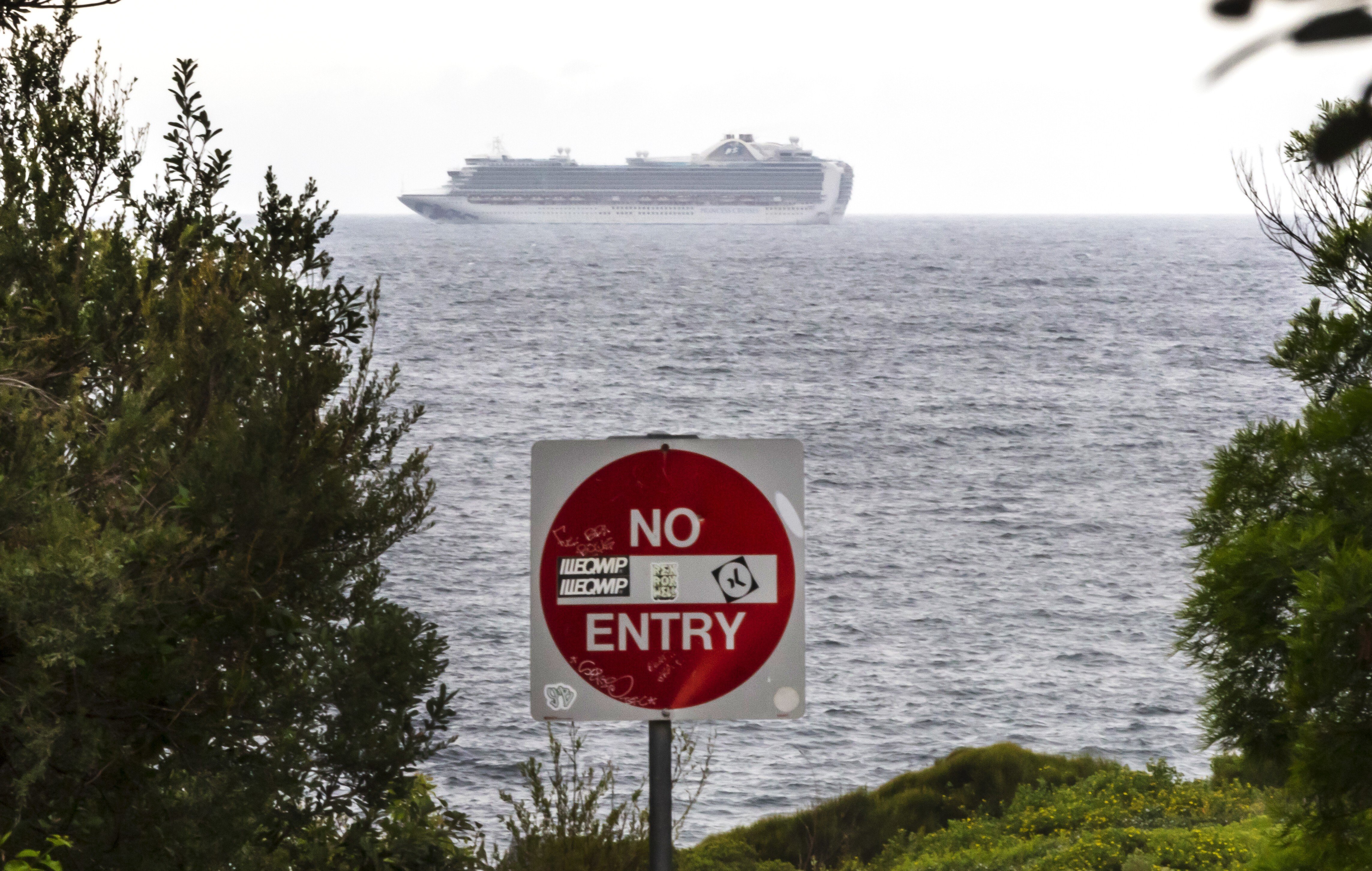 The Ruby Princess cruise ship is seen from Kurnell National Park in Sydney, on Thursday. There are more than 450 Covid-19 infections linked to cruise ships, including 340 cases from the Ruby Princess and 74 from the Ovation of the Seas. Photo: AAP Image