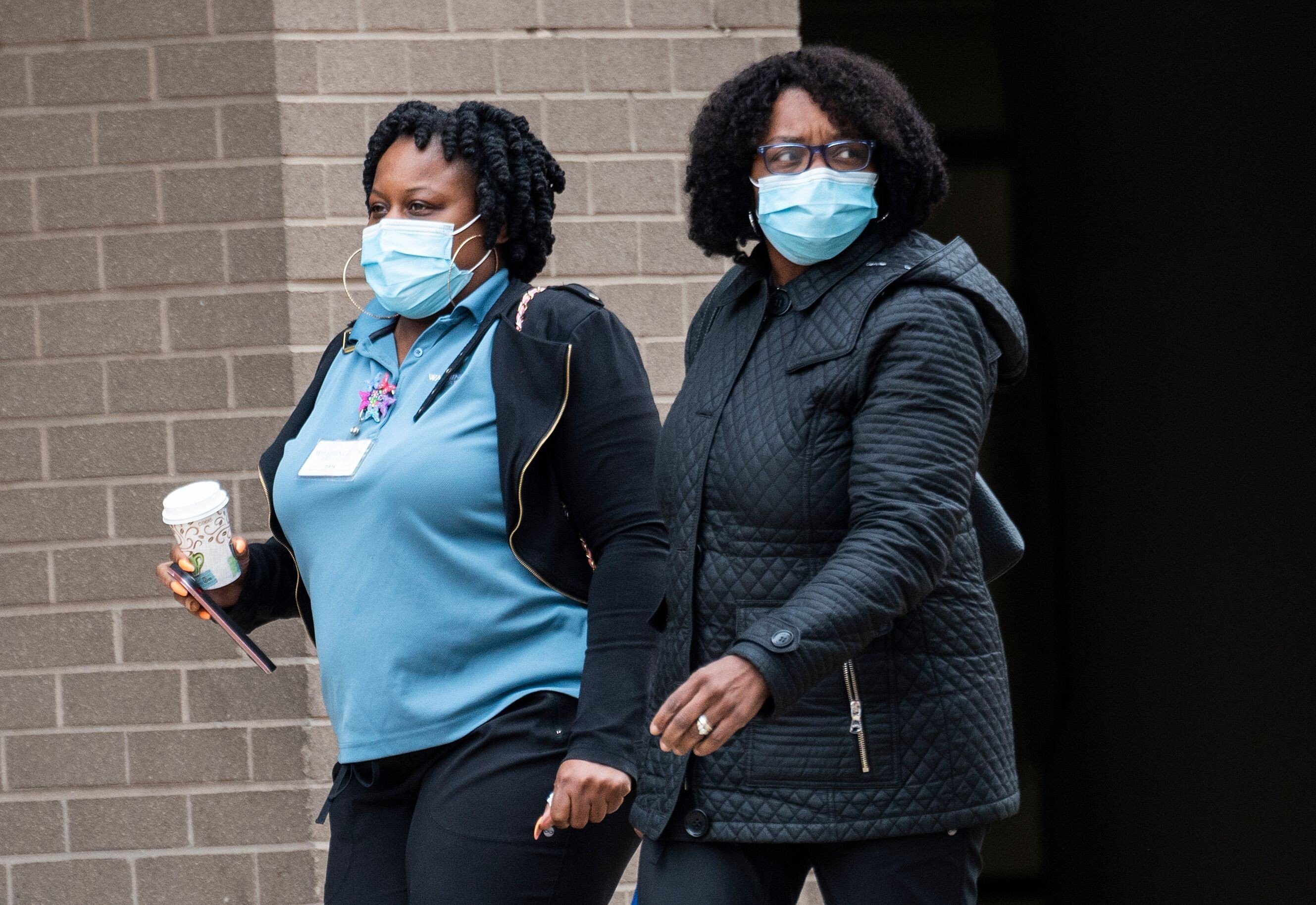 Medical workers wear masks as they walk back to the George Washington University hospital in Washington on March 31. Photo: AFP