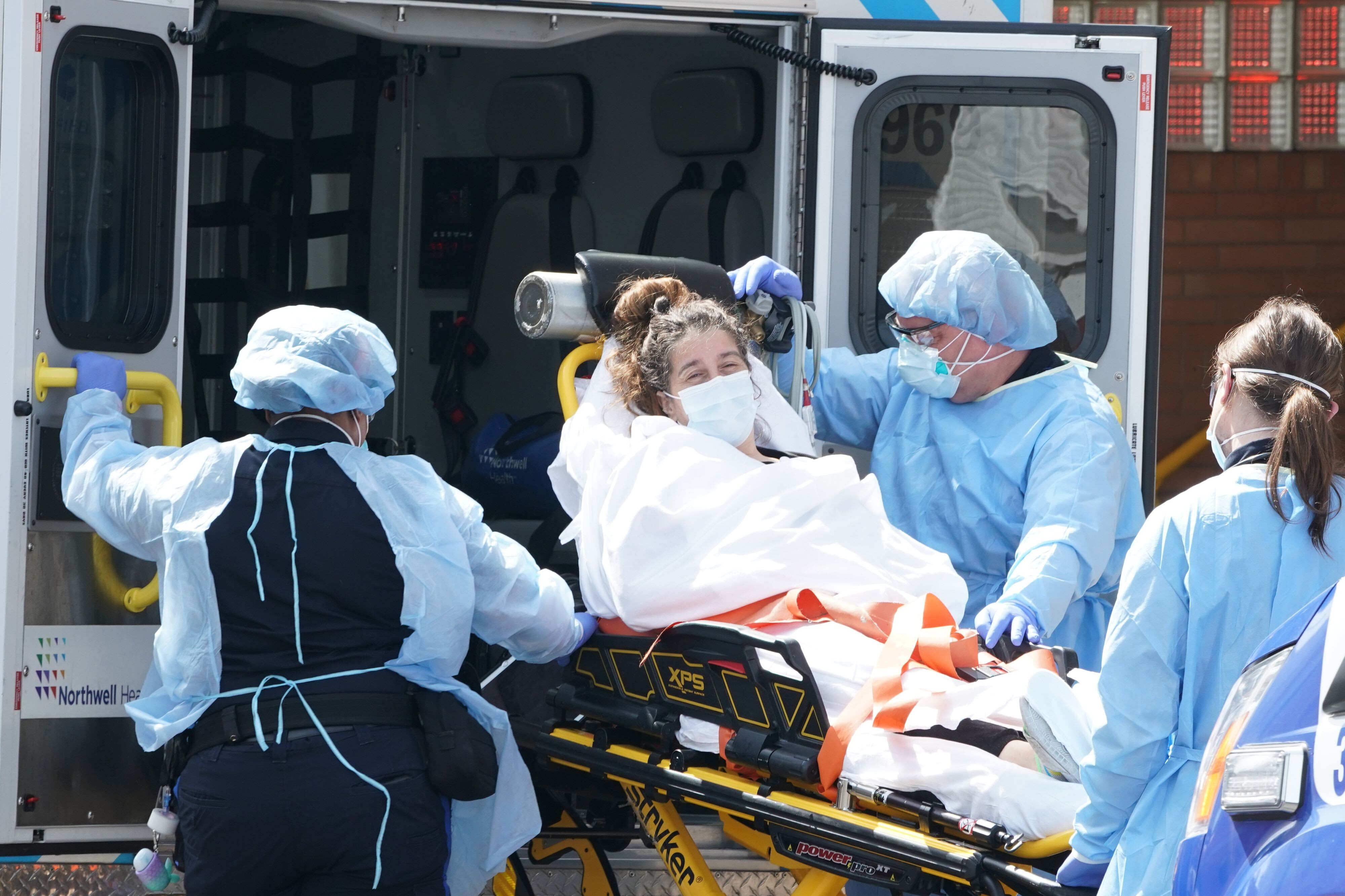 A woman arrives in an ambulance at a hospital in New York on Sunday. Photo: AFP