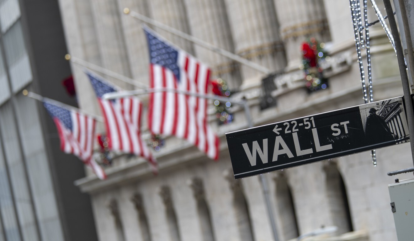 The Wall Street street sign is framed by US flags flying outside the New York Stock Exchange. Photo: AP