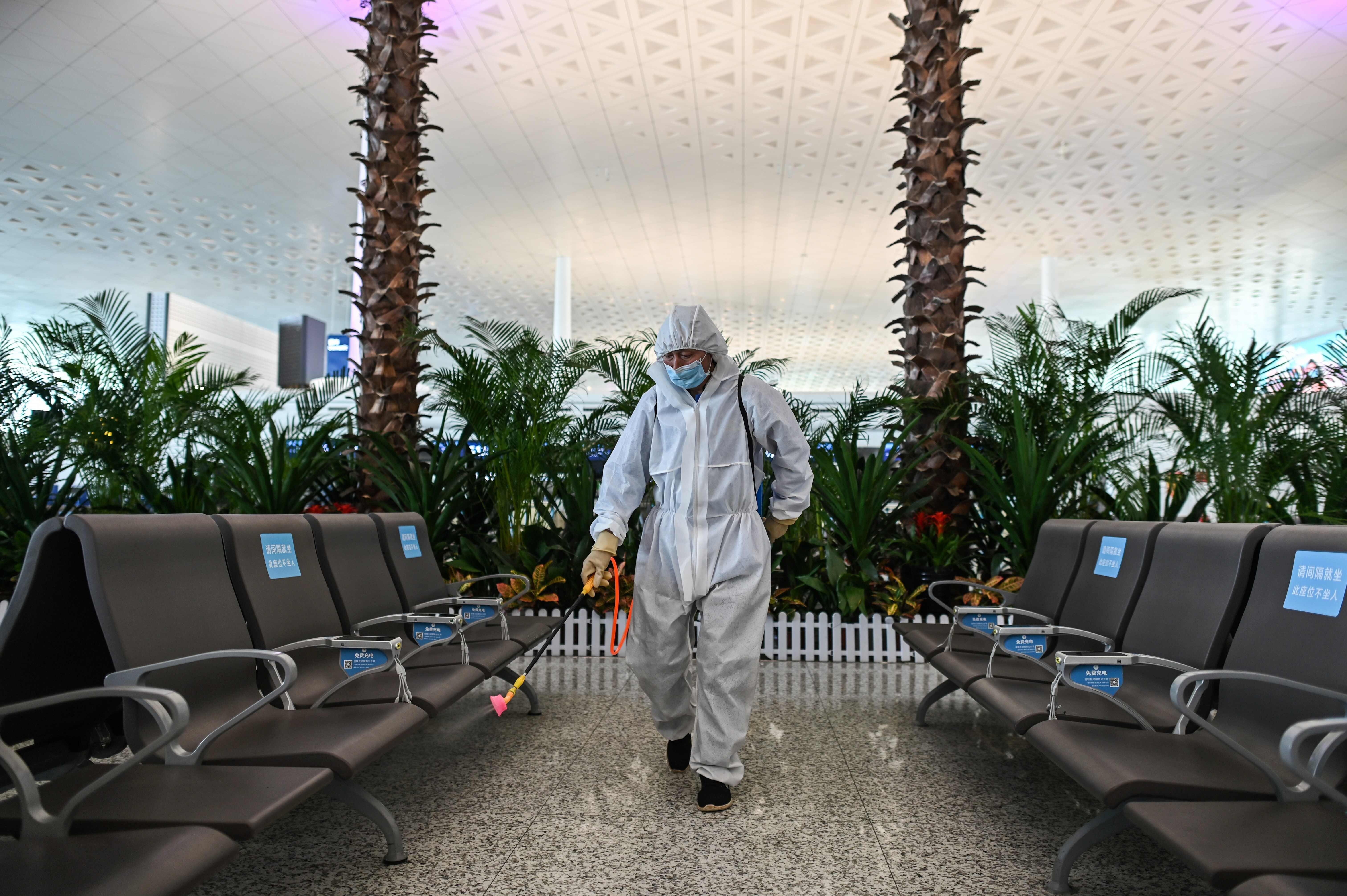 A worker wearing protective gear sprays disinfectant at Wuhan’s Tianhe Airport after it was reopened on April 8. Photo: AFP