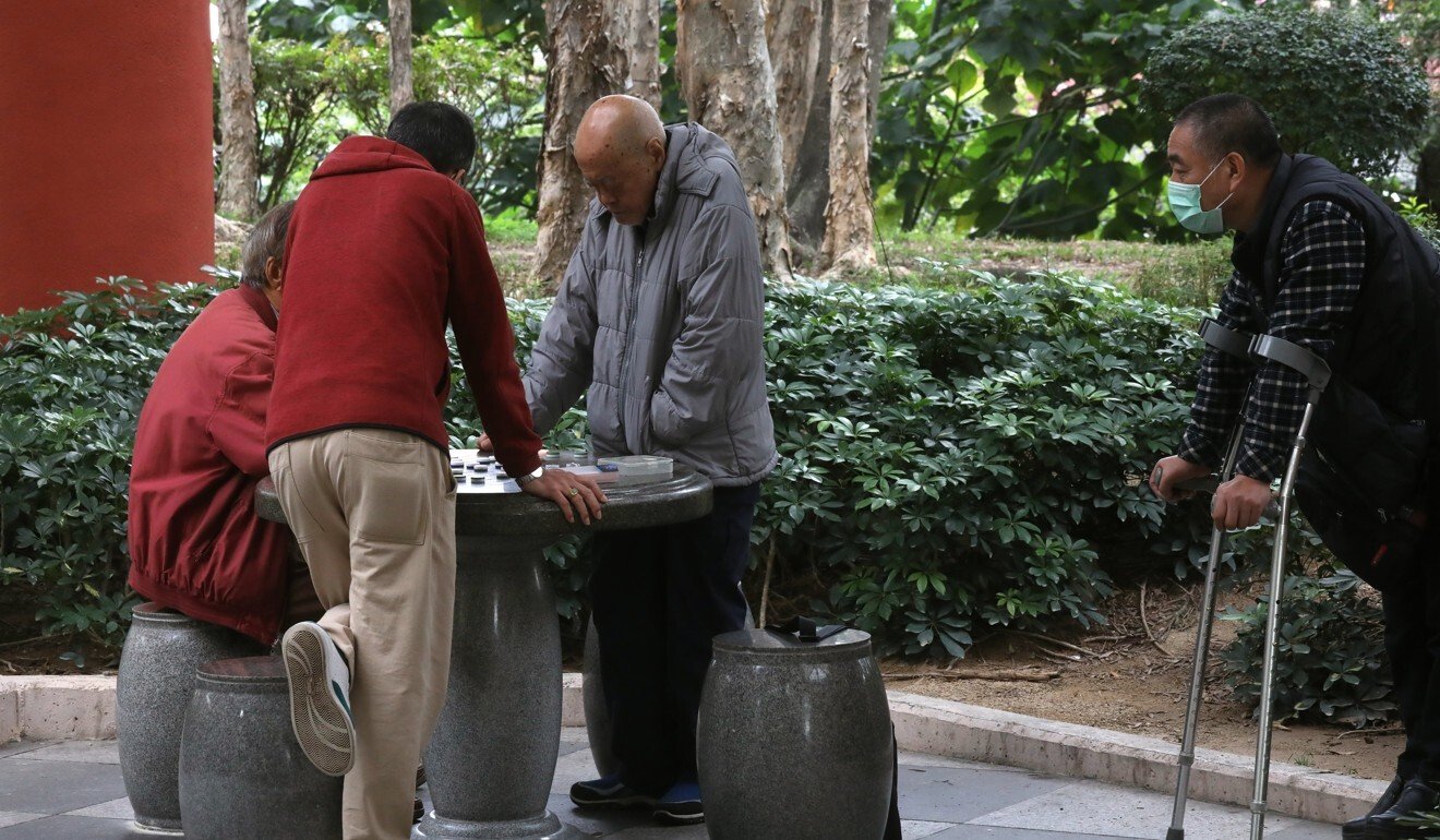 Board game players in Tuen Mun Park, northern Hong Kong, comply with the social-distancing legislation by sticking to a group of four. Photo: K.Y. Cheng