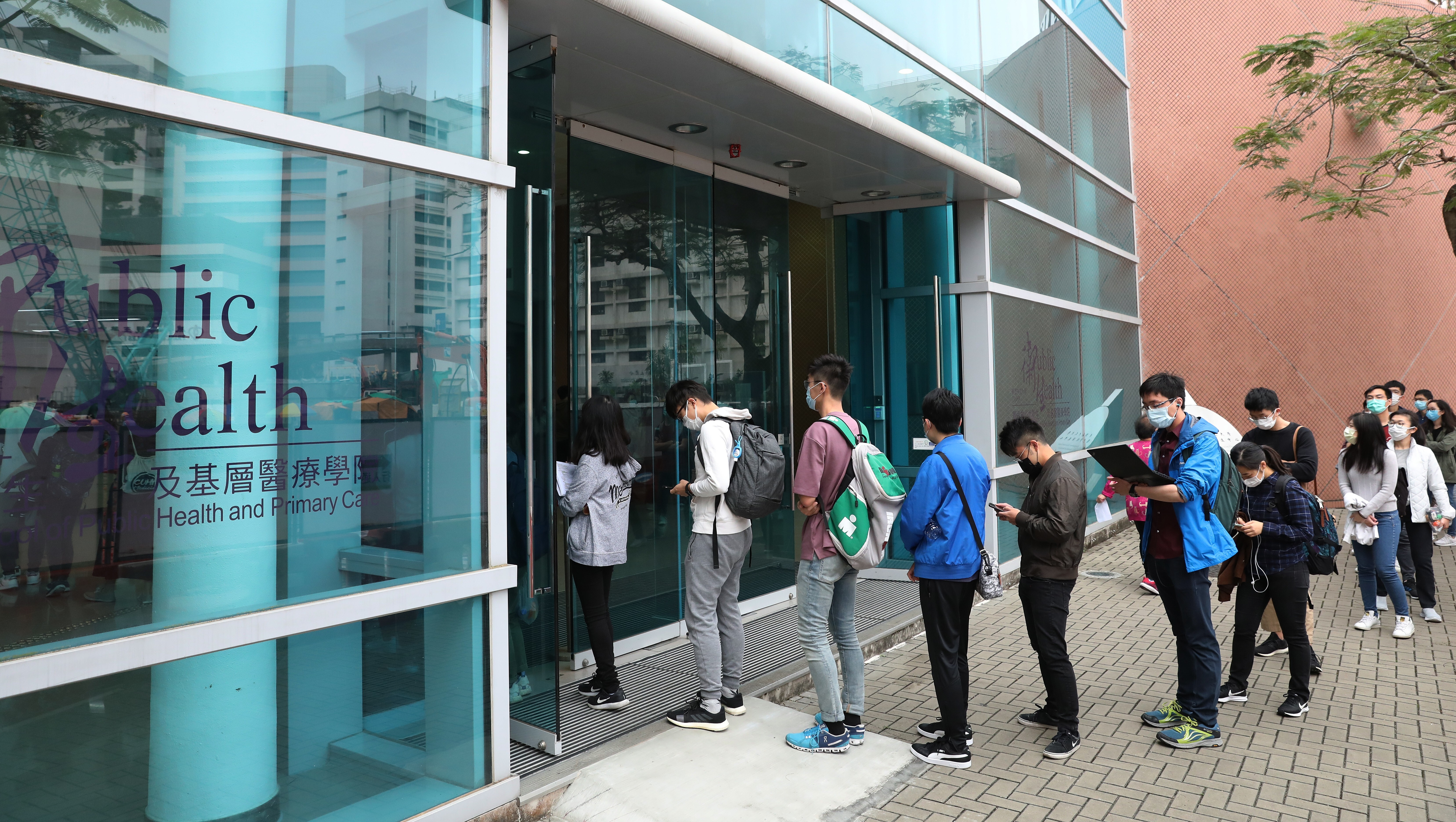Chinese University of Hong Kong students queue to have their temperature checked before sitting an exam at their campus in Sha Tin on April 3. Class disruptions have greatly affected campus life since last September. Photo: Nora Tam