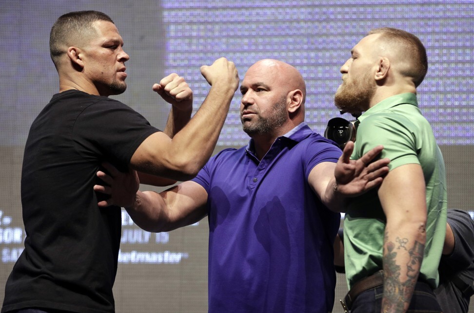 Dana White, stands between Nate Diaz and Conor McGregor during a news conference in Las Vegas for UFC 202. Photo: AP