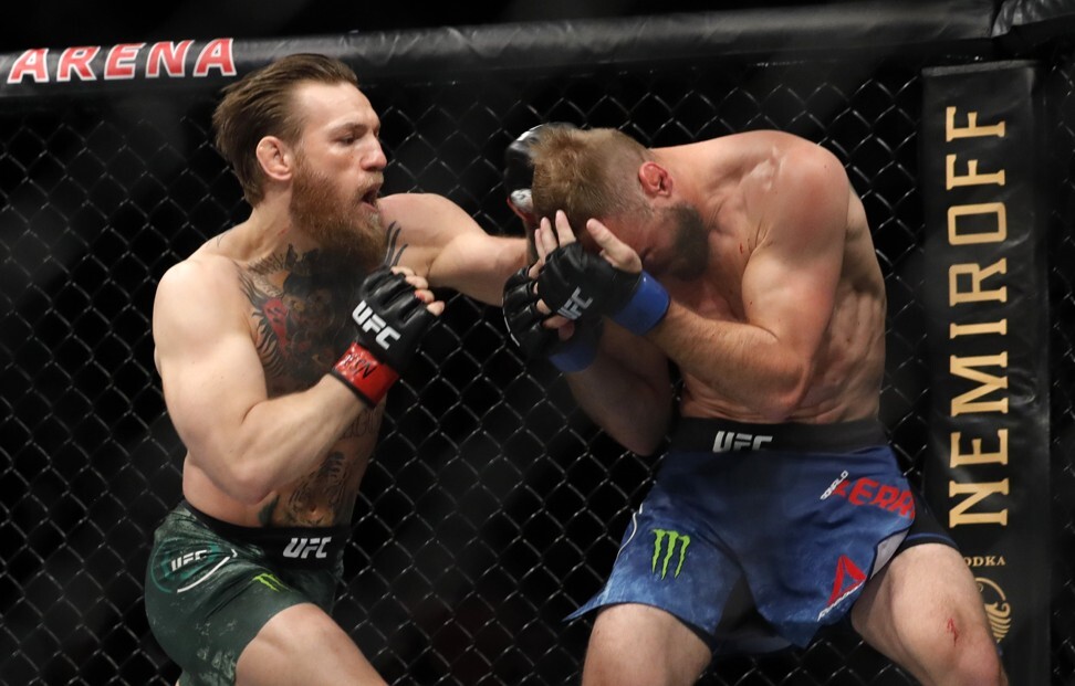 Conor McGregor punches Donald Cerrone. Photo: AFP