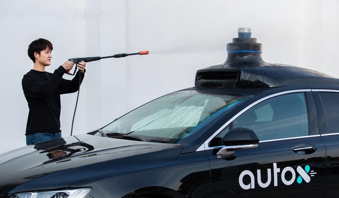 High pressure water being sprayed at an AutoX vehicle to test its sensor unit. Photo: Handout